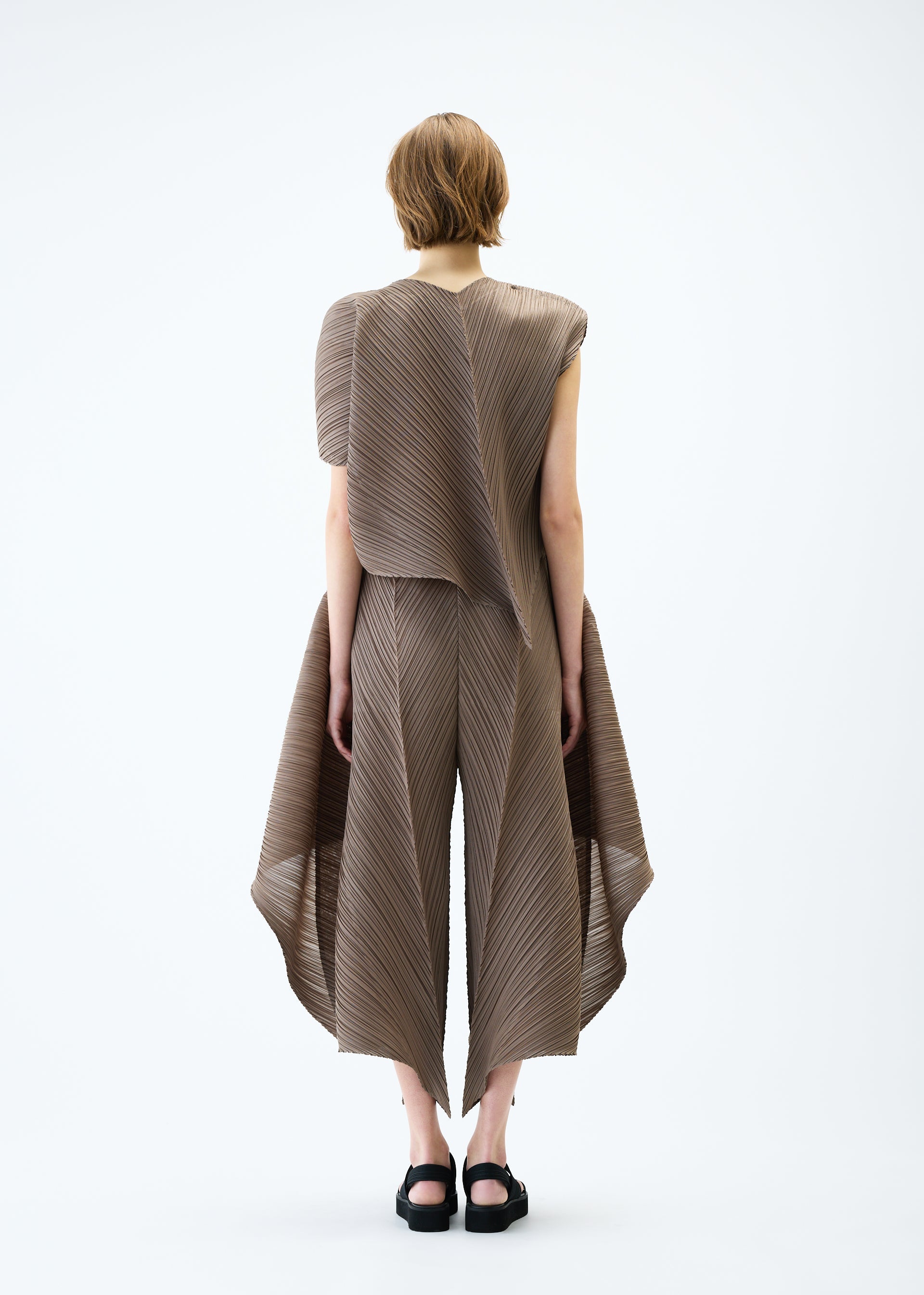 A model wears the PLEATS PLEASE ISSEY MIYAKE FLARE top.