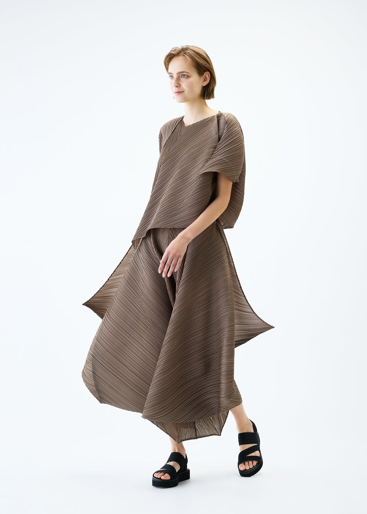 A model wears the PLEATS PLEASE ISSEY MIYAKE FLARE top.