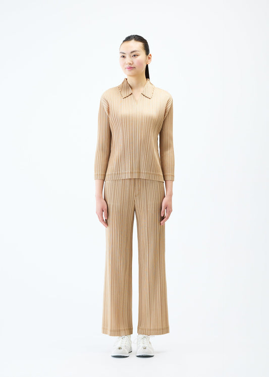 A model wears the PLEATS PLEASE ISSEY MIYAKE COTTON DENIM top.