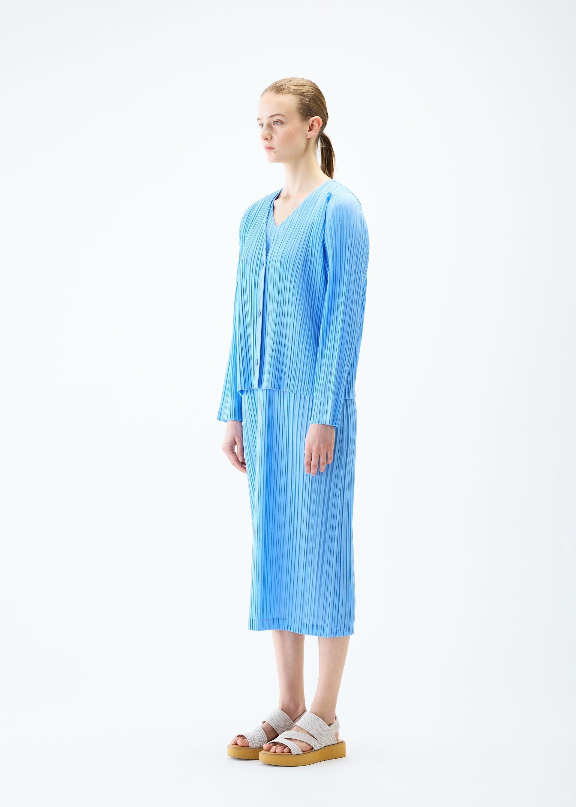 A model wears the PLEATS PLEASE ISSEY MIYAKE RAMIE PLEATS cardigan.