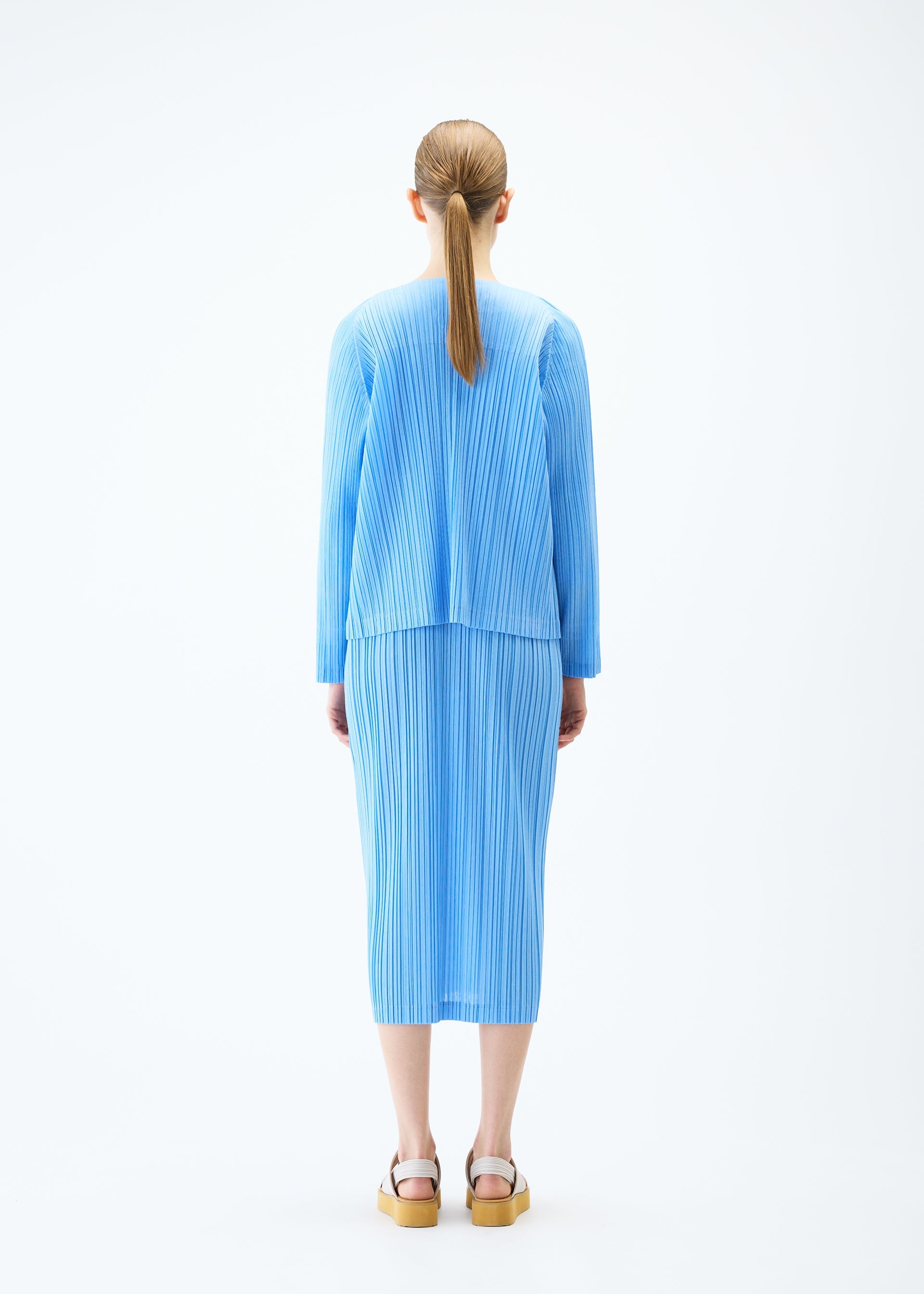 A model wears the PLEATS PLEASE ISSEY MIYAKE RAMIE PLEATS cardigan.