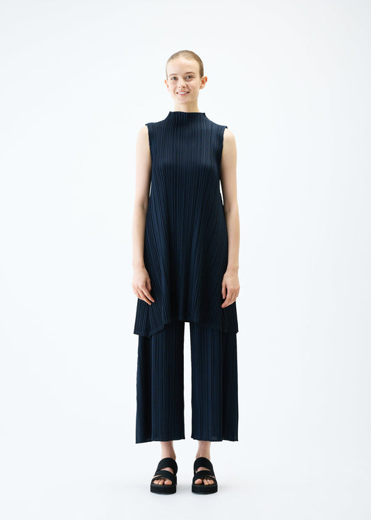 A model wears the PLEATS PLEASE ISSEY MIYAKE MELLOW PLEATS tunic.