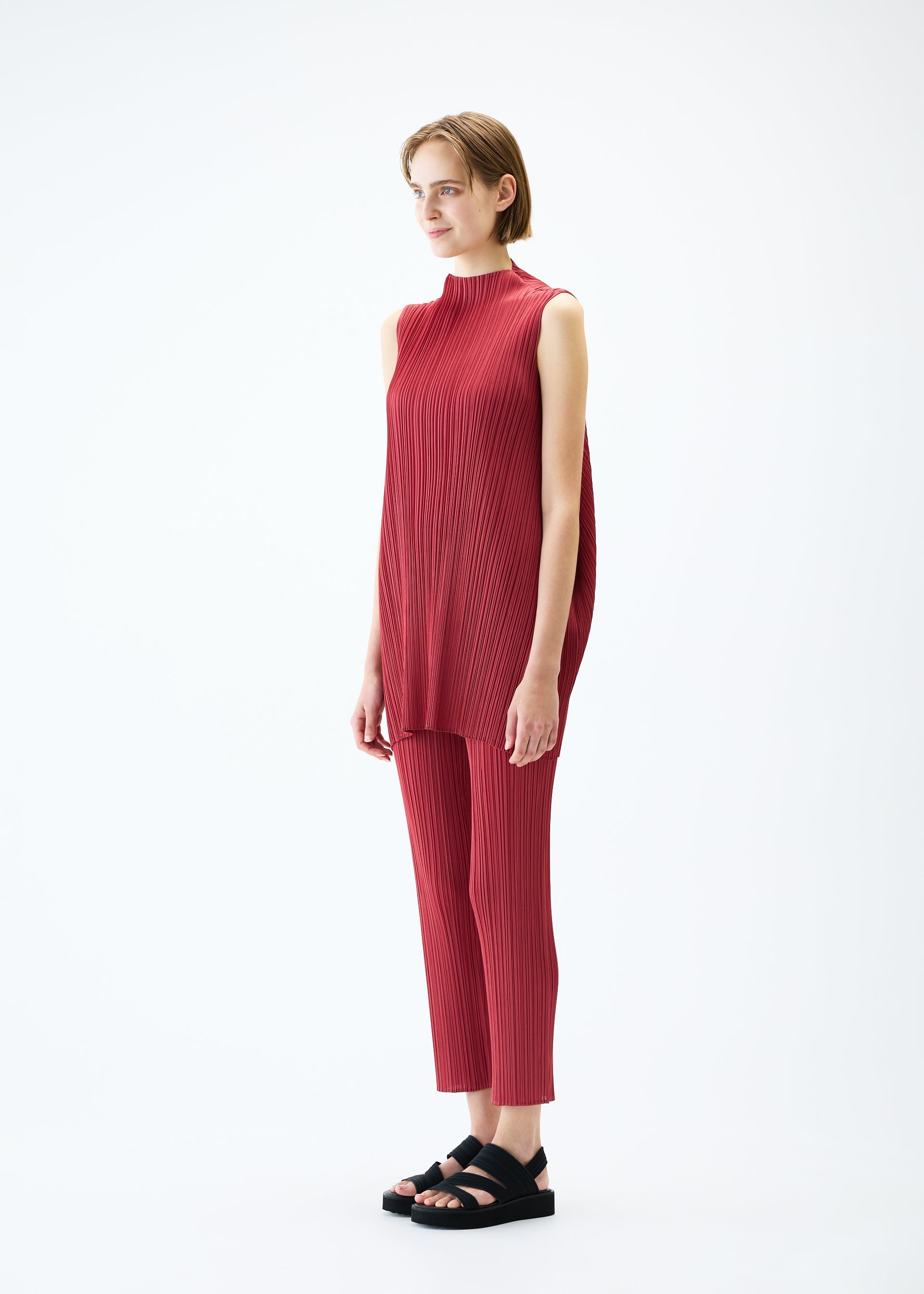 A model wears the PLEATS PLEASE ISSEY MIYAKE LAMP SHADE tunic.