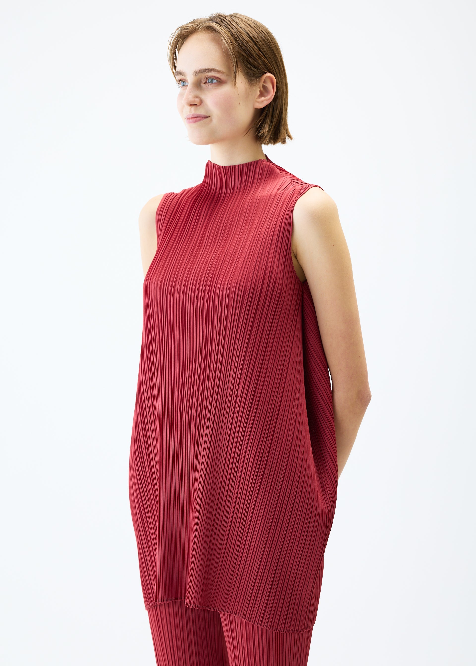 A model wears the PLEATS PLEASE ISSEY MIYAKE LAMP SHADE tunic.