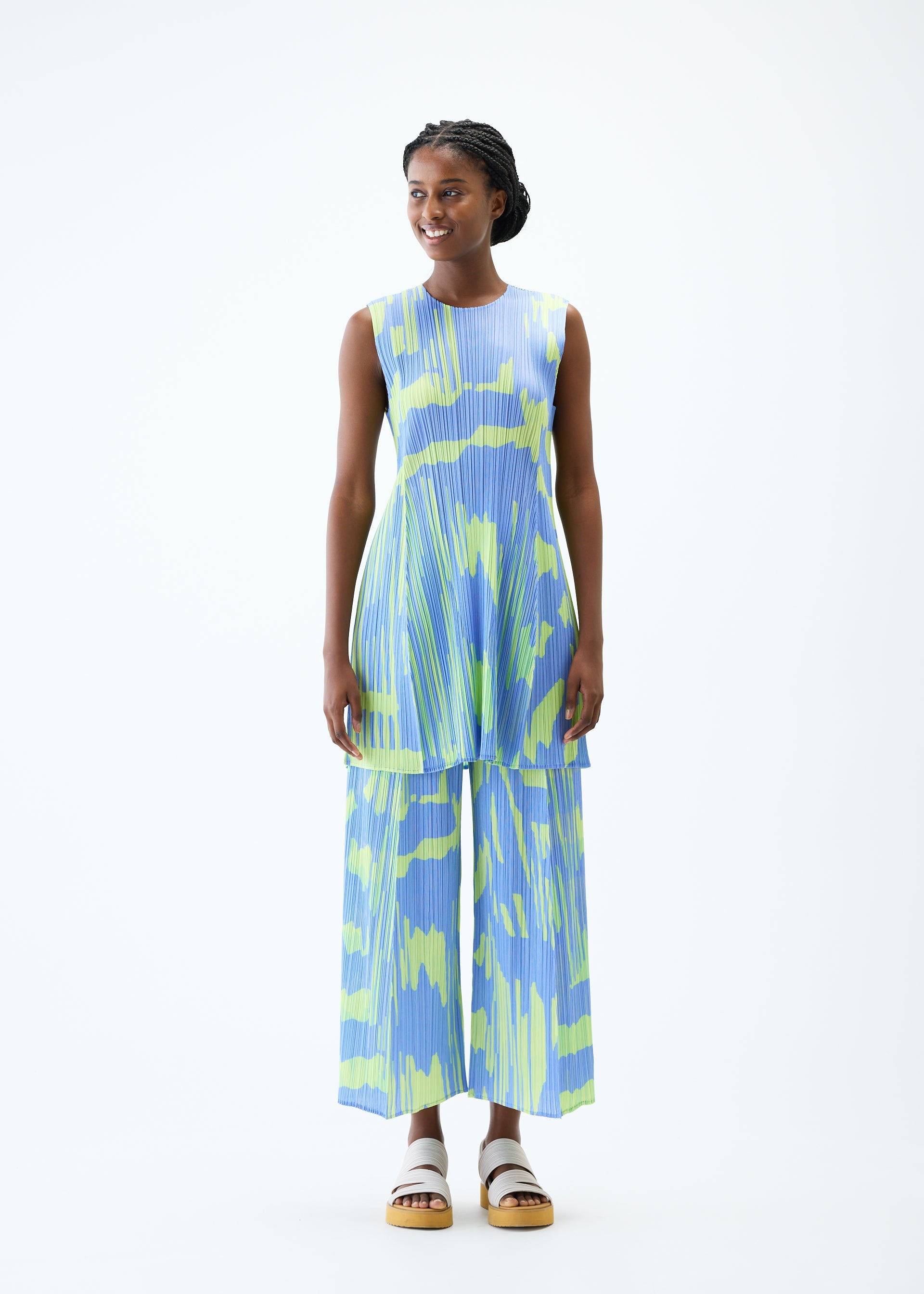A model wears the PLEATS PLEASE ISSEY MIYAKE REFRACTION tunic.