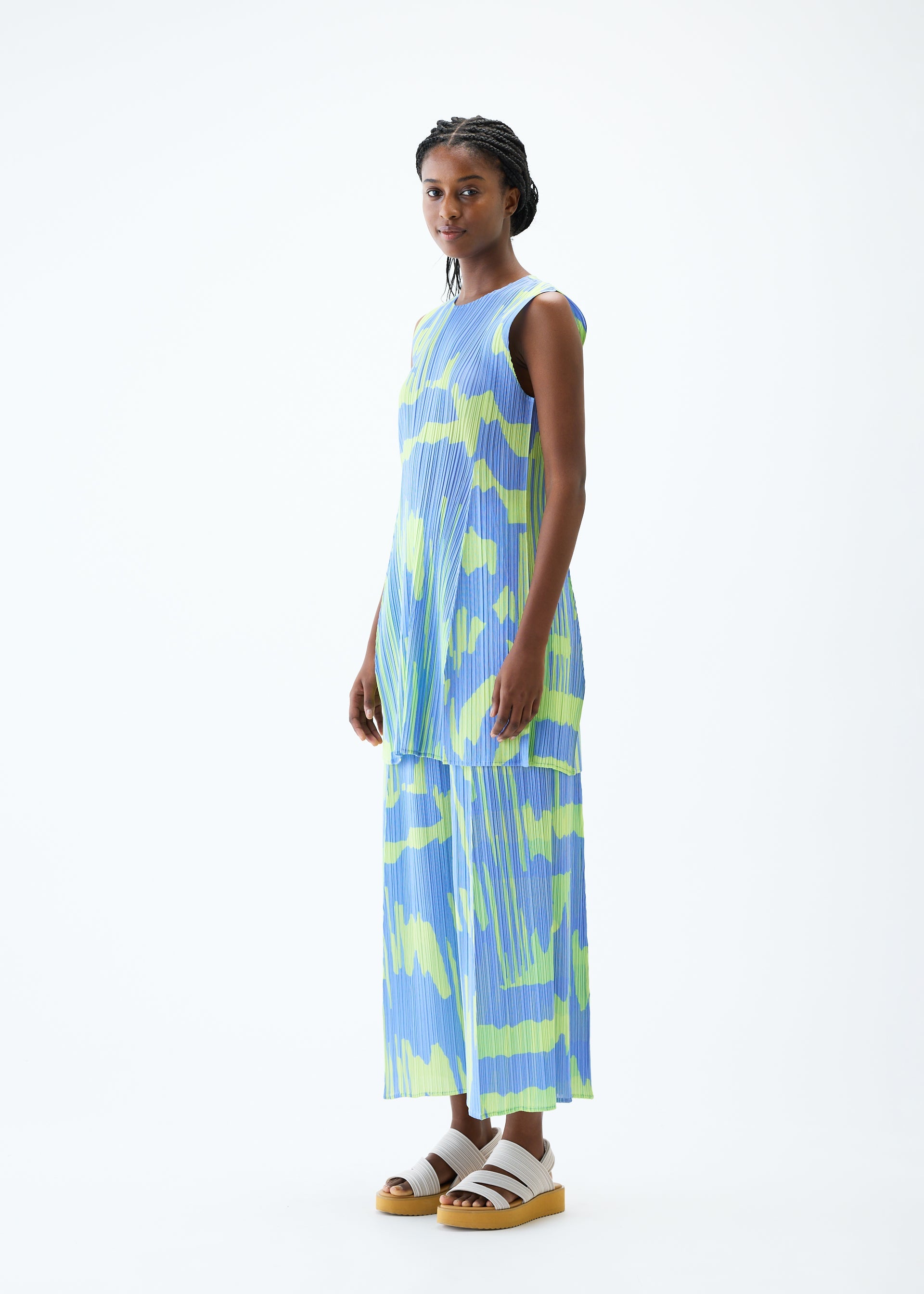 A model wears the PLEATS PLEASE ISSEY MIYAKE REFRACTION tunic.