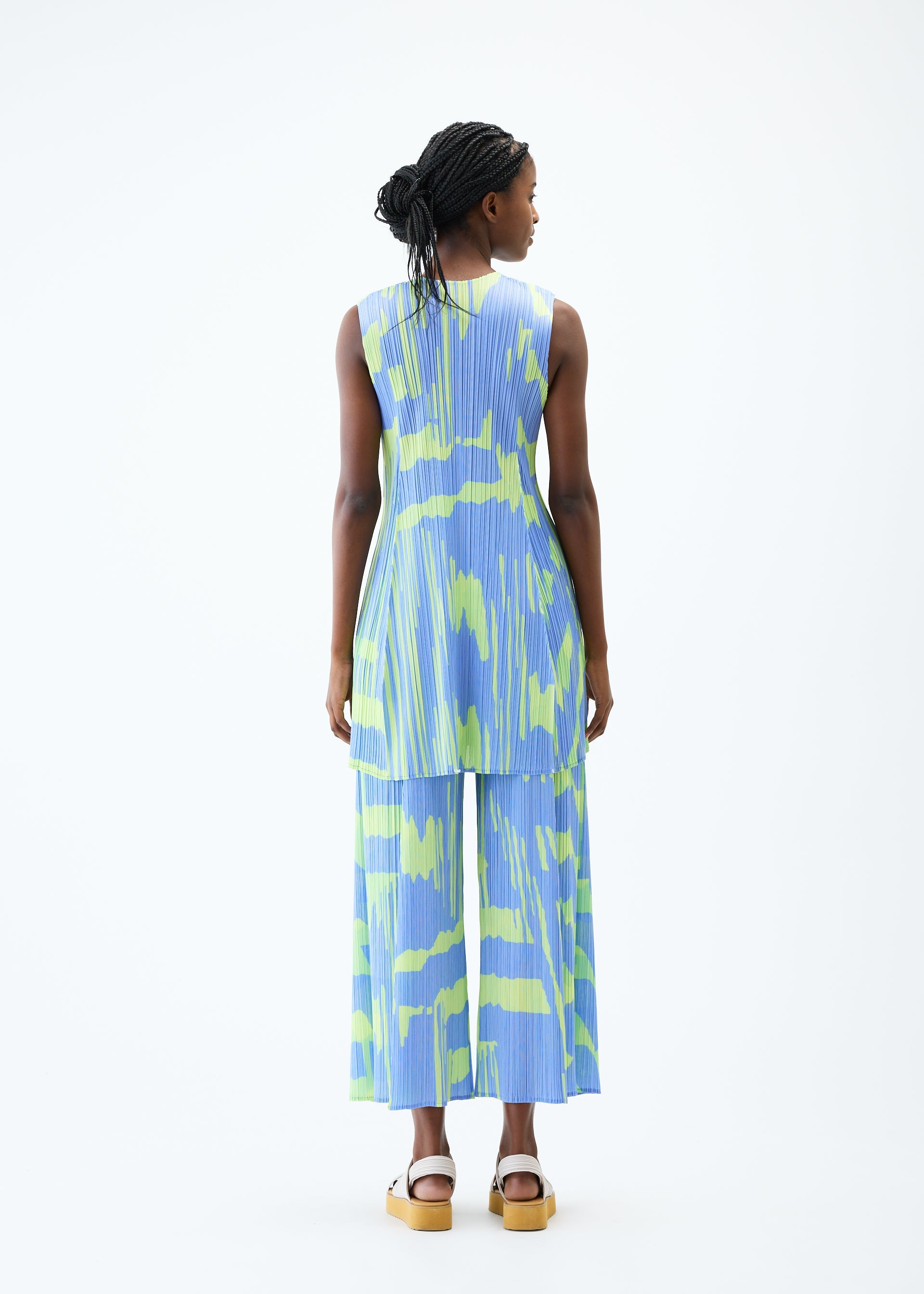 A model wears the PLEATS PLEASE ISSEY MIYAKE REFRACTION tunic.