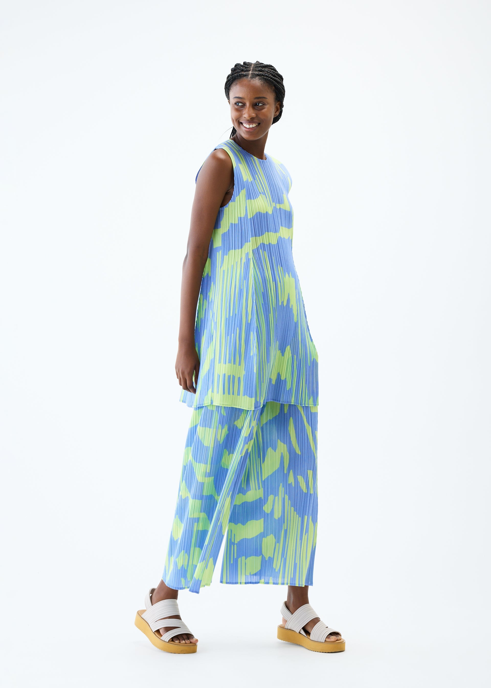 A model wears the PLEATS PLEASE ISSEY MIYAKE REFRACTION tunic.