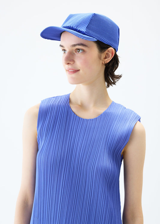 A model wears the PLEATS PLEASE ISSEY MIYAKE PLEATS CAP hat.