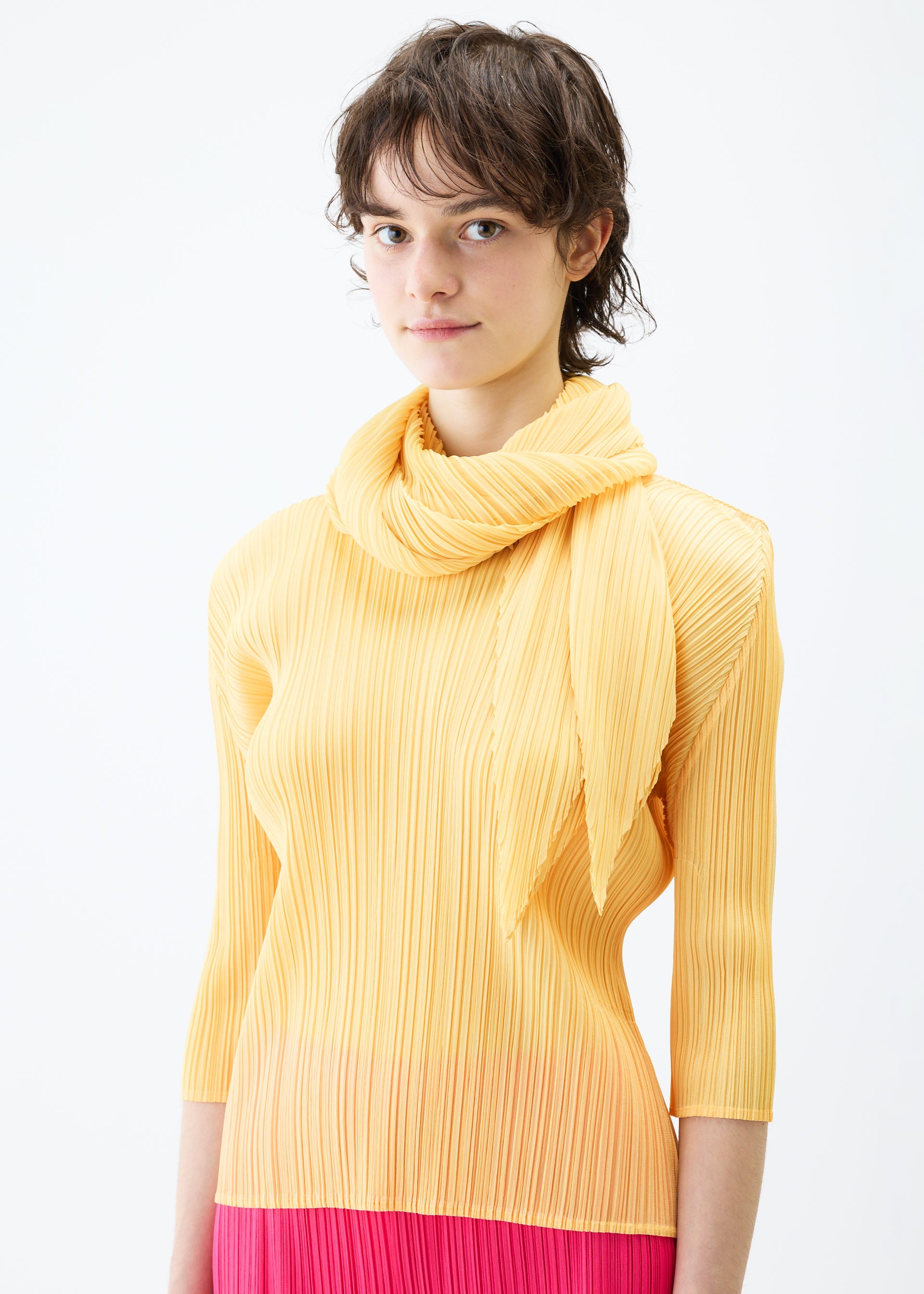 A model wears the PLEATS PLEASE ISSEY MIYAKE MONTHLY SCARF MARCH stole.