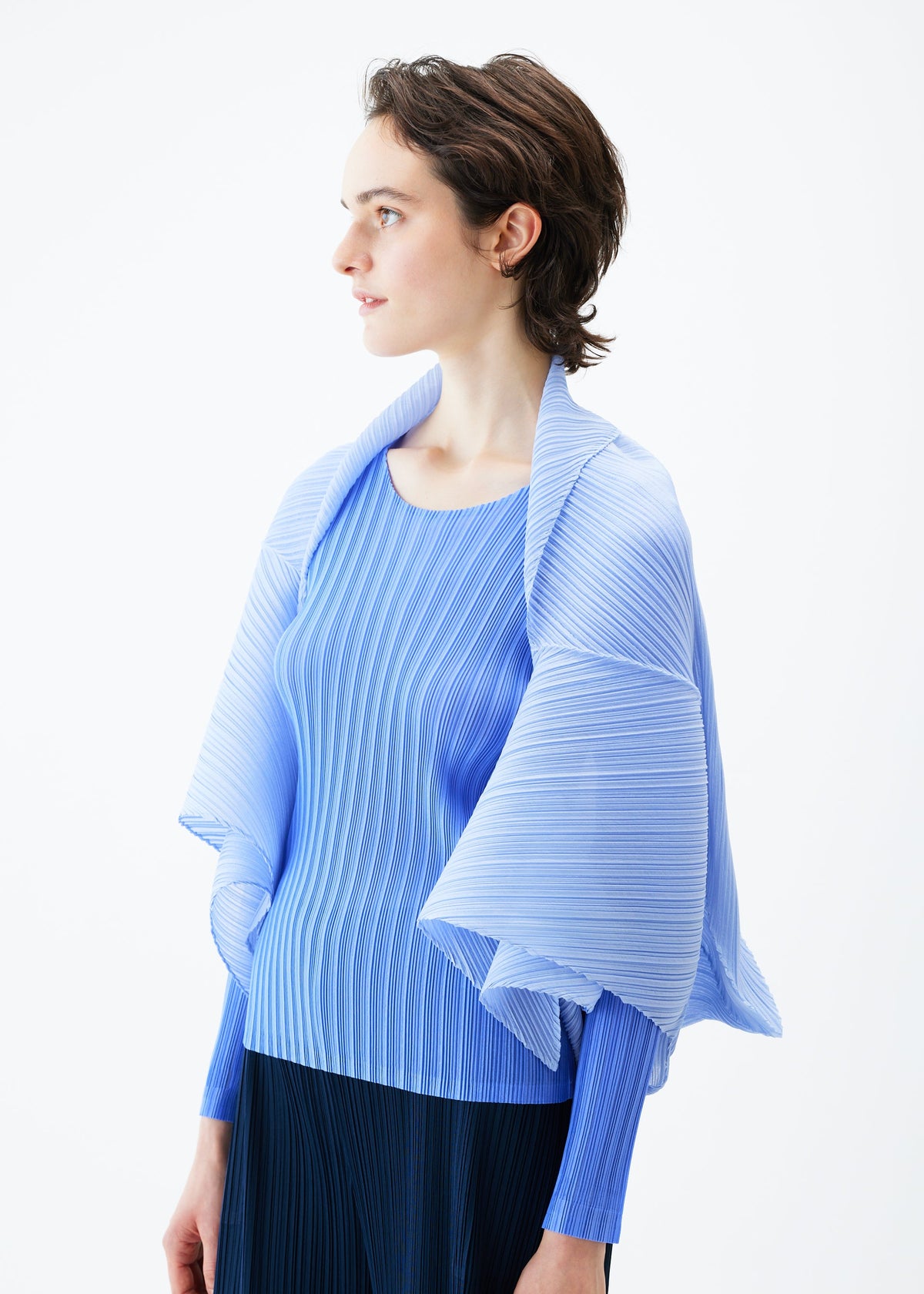 A model wears the PLEATS PLEASE ISSEY MIYAKE ZIGZAG PLEATS SCARF stole.