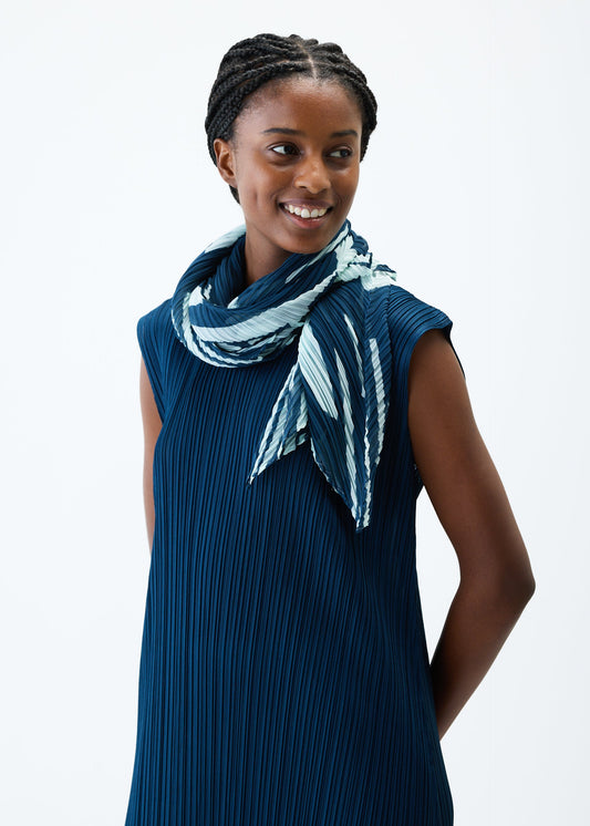 A model wears the PLEATS PLEASE ISSEY MIYAKE REFRACTION SCARF stole.