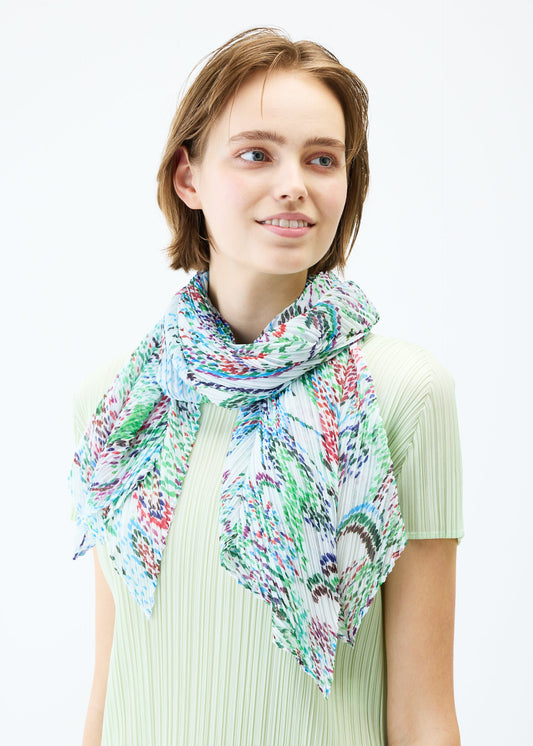 A model wears the PLEATS PLEASE ISSEY MIYAKE LIGHT FESTIVAL SCARF stole.