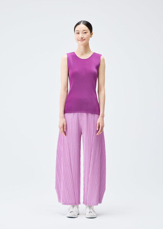 A model wears the PLEATS PLEASE ISSEY MIYAKE MIST SEPTEMBER top.