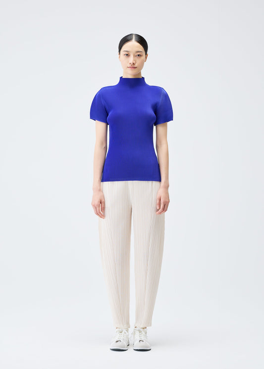 A model wears the PLEATS PLEASE ISSEY MIYAKE MIST SEPTEMBER top.