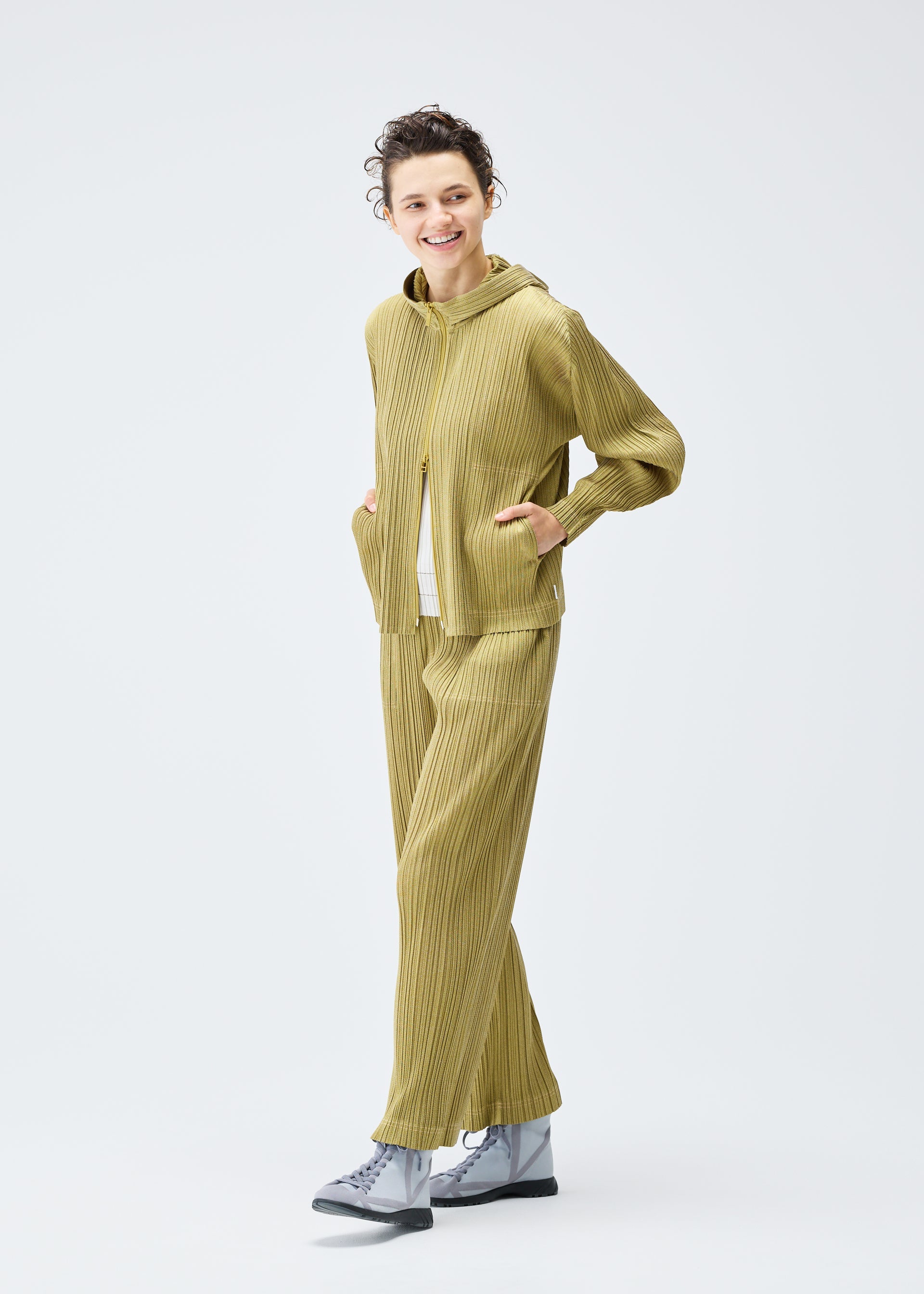 A model wears the PLEATS PLEASE ISSEY MIYAKE COTTON DENIM jacket.