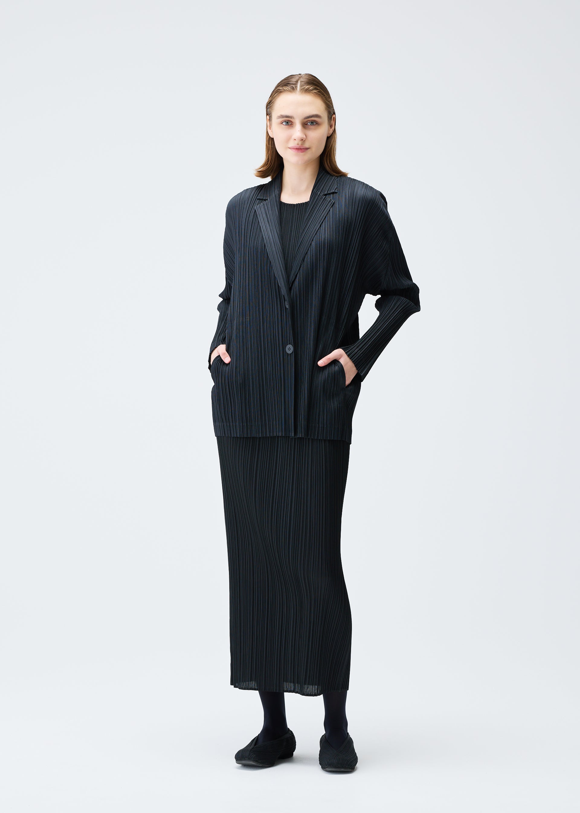 A model wears the PLEATS PLEASE ISSEY MIYAKE PLEATS JACKET jacket.