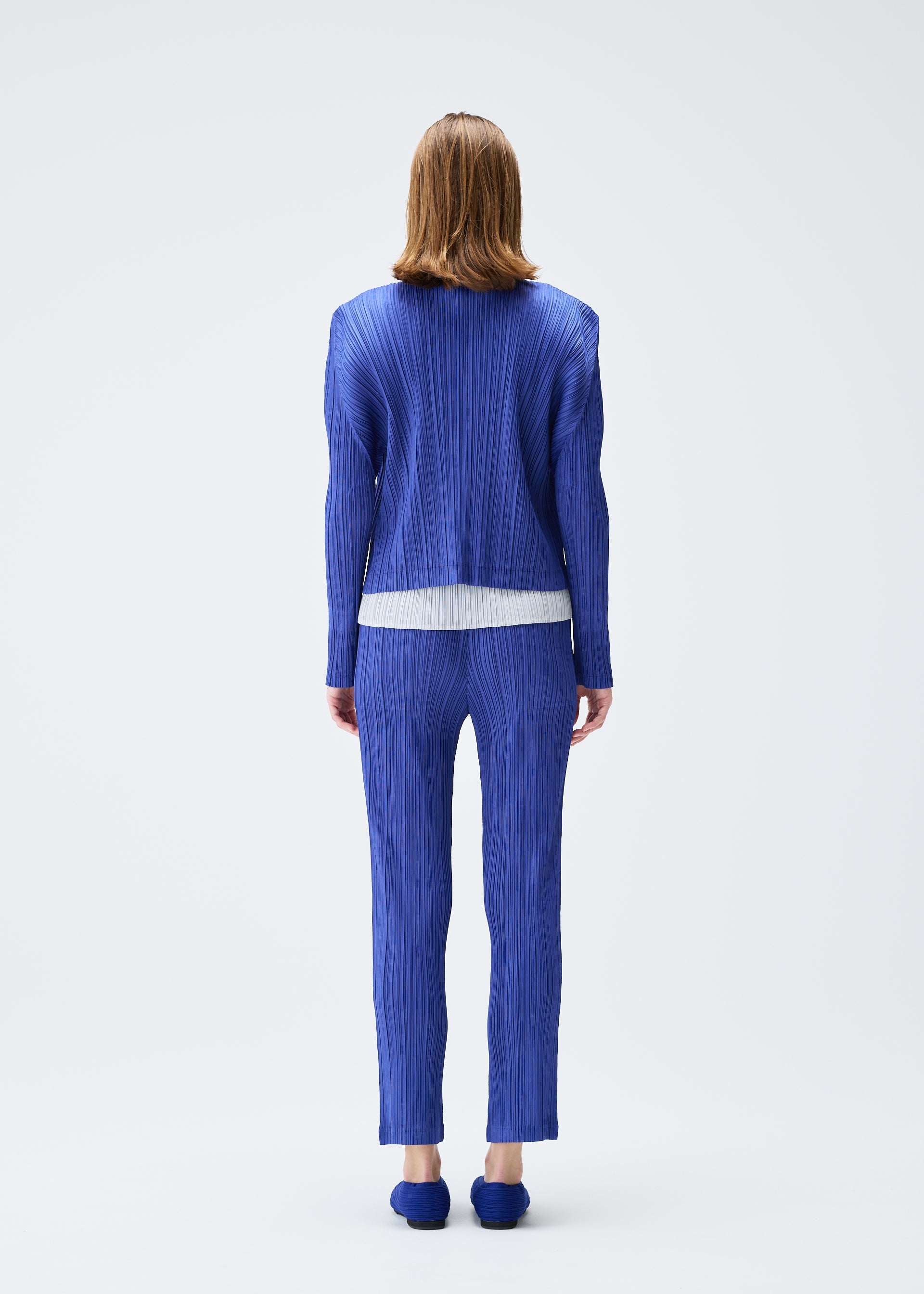 A model wears the PLEATS PLEASE ISSEY MIYAKE PLEATS JACKET jacket.