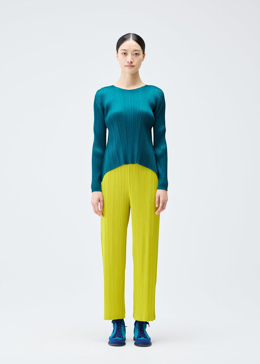 A model wears the PLEATS PLEASE ISSEY MIYAKE MONTHLY COLORS OCTOBER trousers.