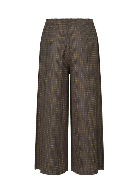 A detail shot of the PLEATS PLEASE ISSEY MIYAKE COTTON SKIP trousers.