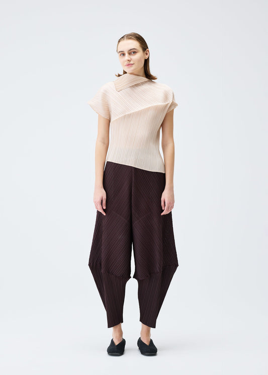 A model wears the PLEATS PLEASE ISSEY MIYAKE LEAP trousers.