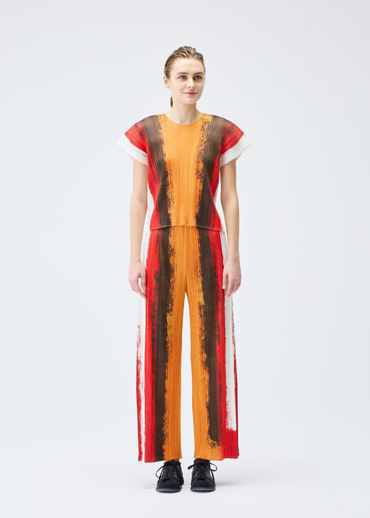 A model wears the PLEATS PLEASE ISSEY MIYAKE JUMP trousers.