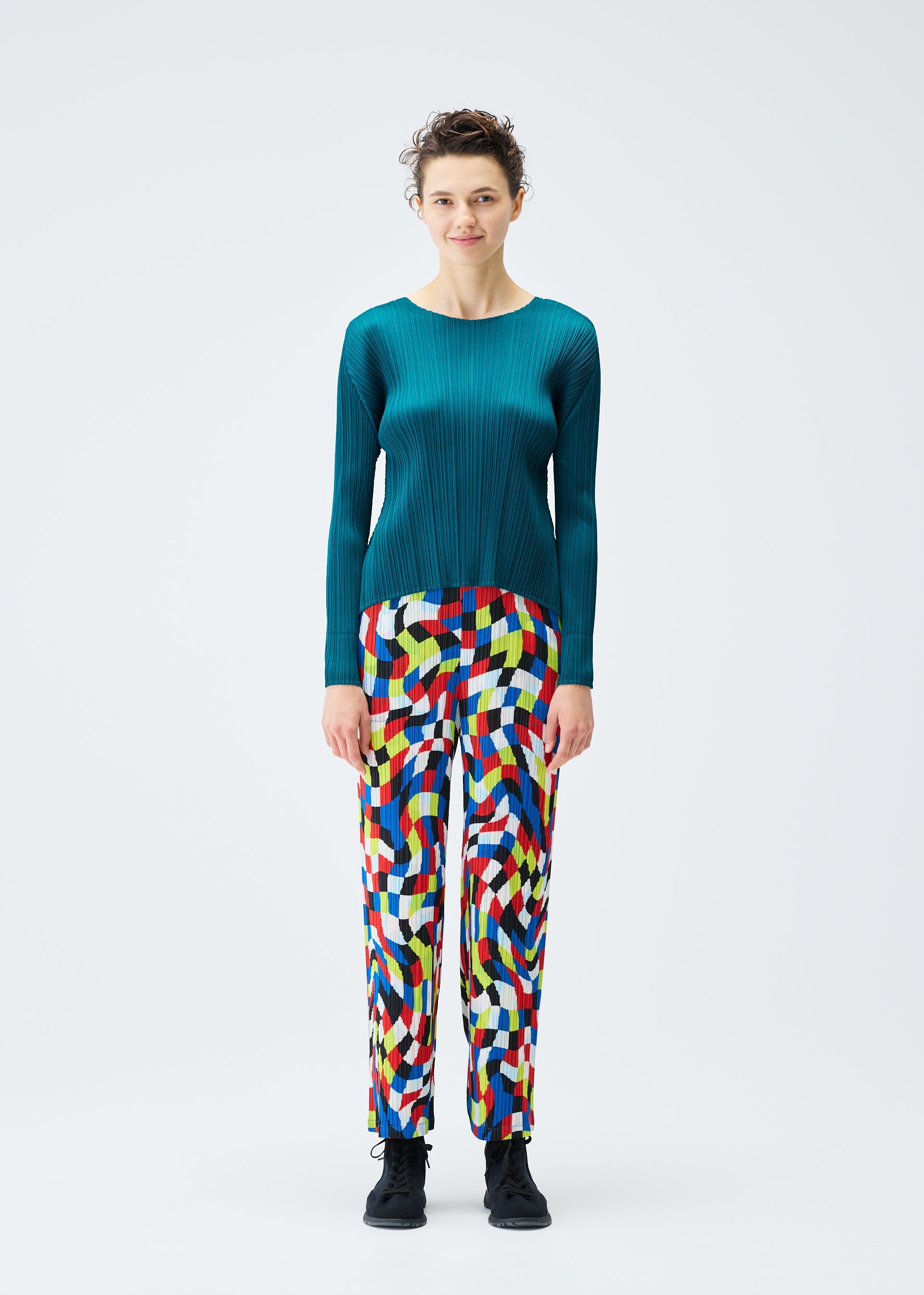 A model wears the PLEATS PLEASE ISSEY MIYAKE DANCING SQUARE trousers.