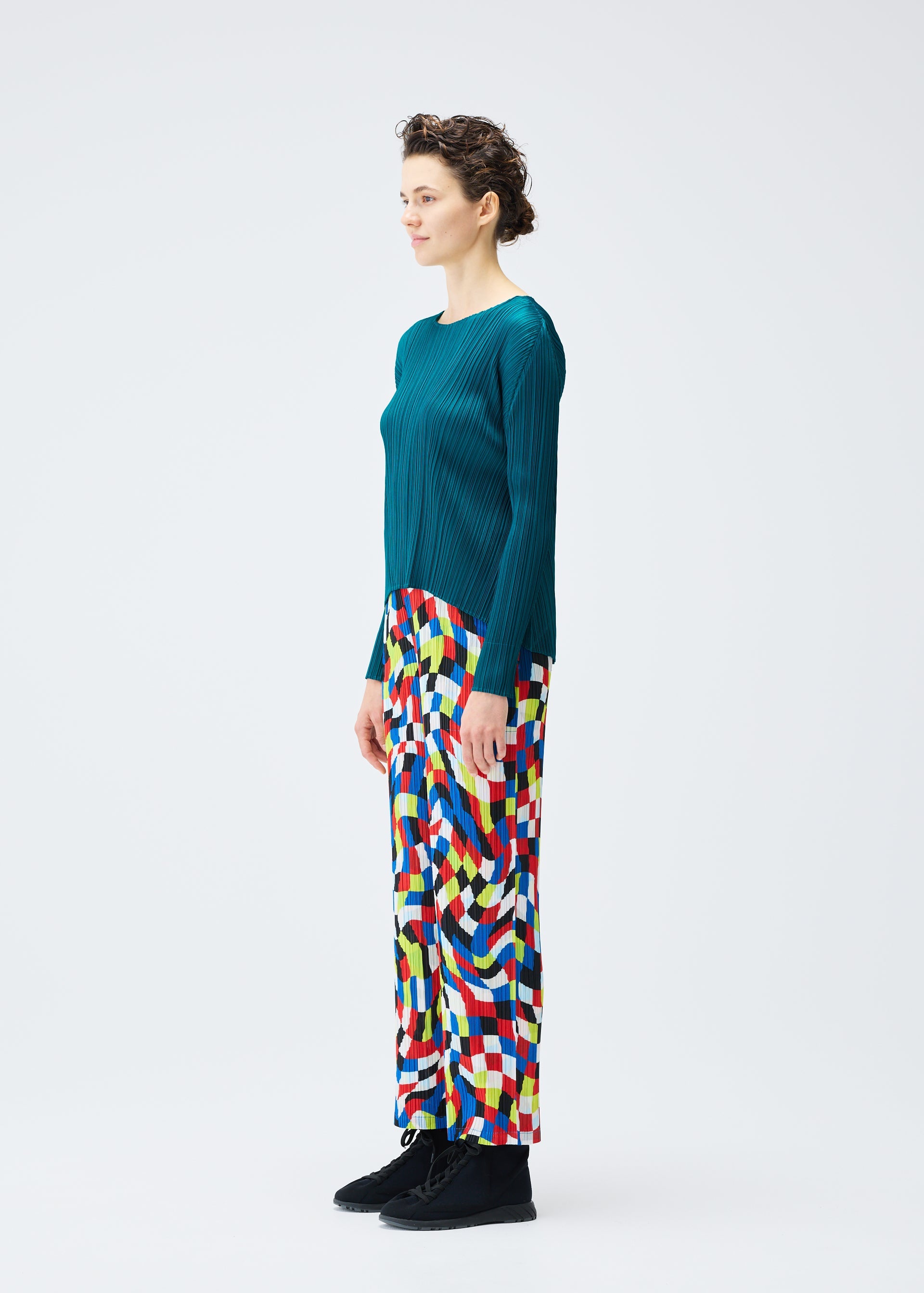 A model wears the PLEATS PLEASE ISSEY MIYAKE DANCING SQUARE trousers.
