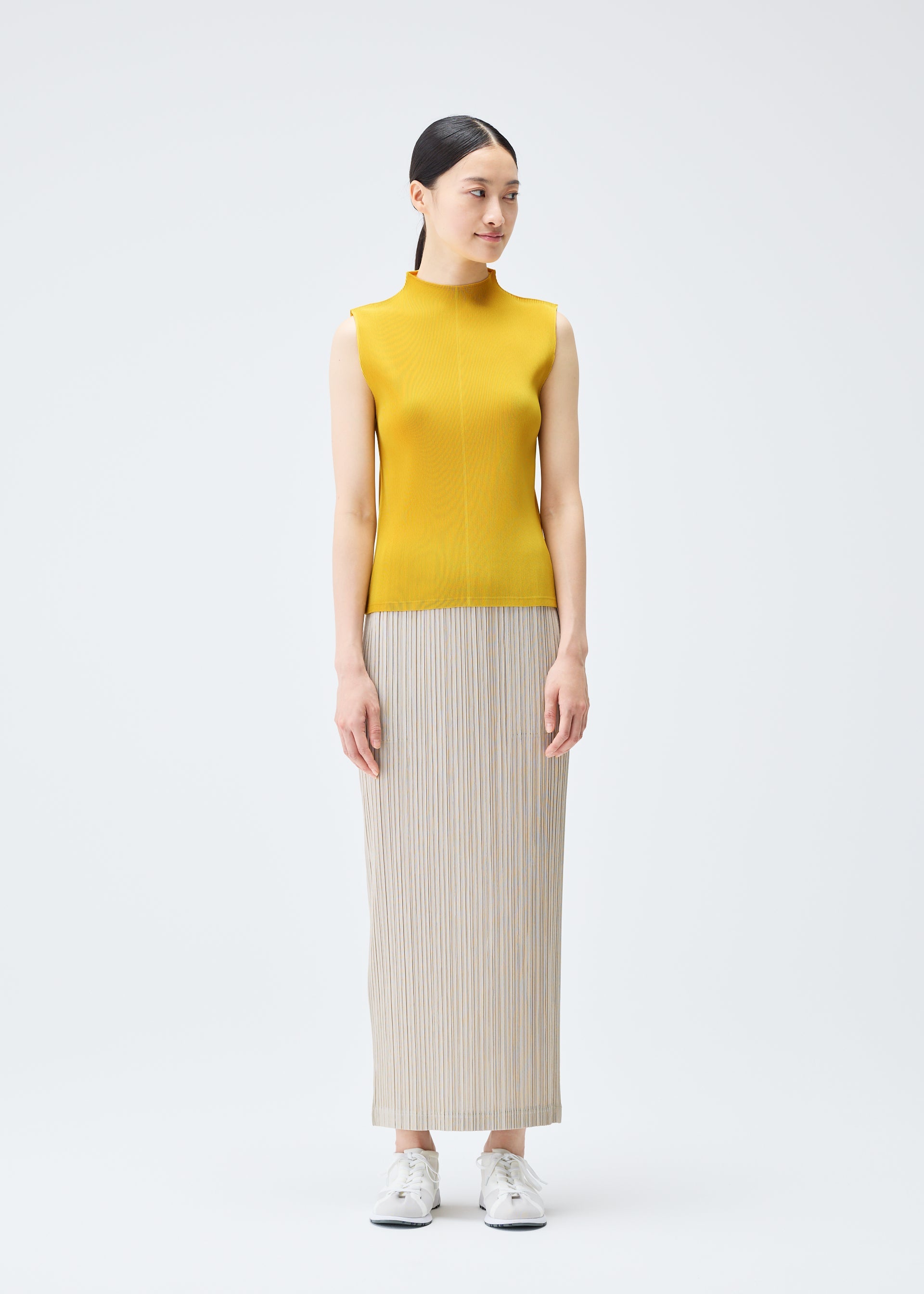 A model wears the PLEATS PLEASE ISSEY MIYAKE THICKER BOTTOMS 1 skirt.