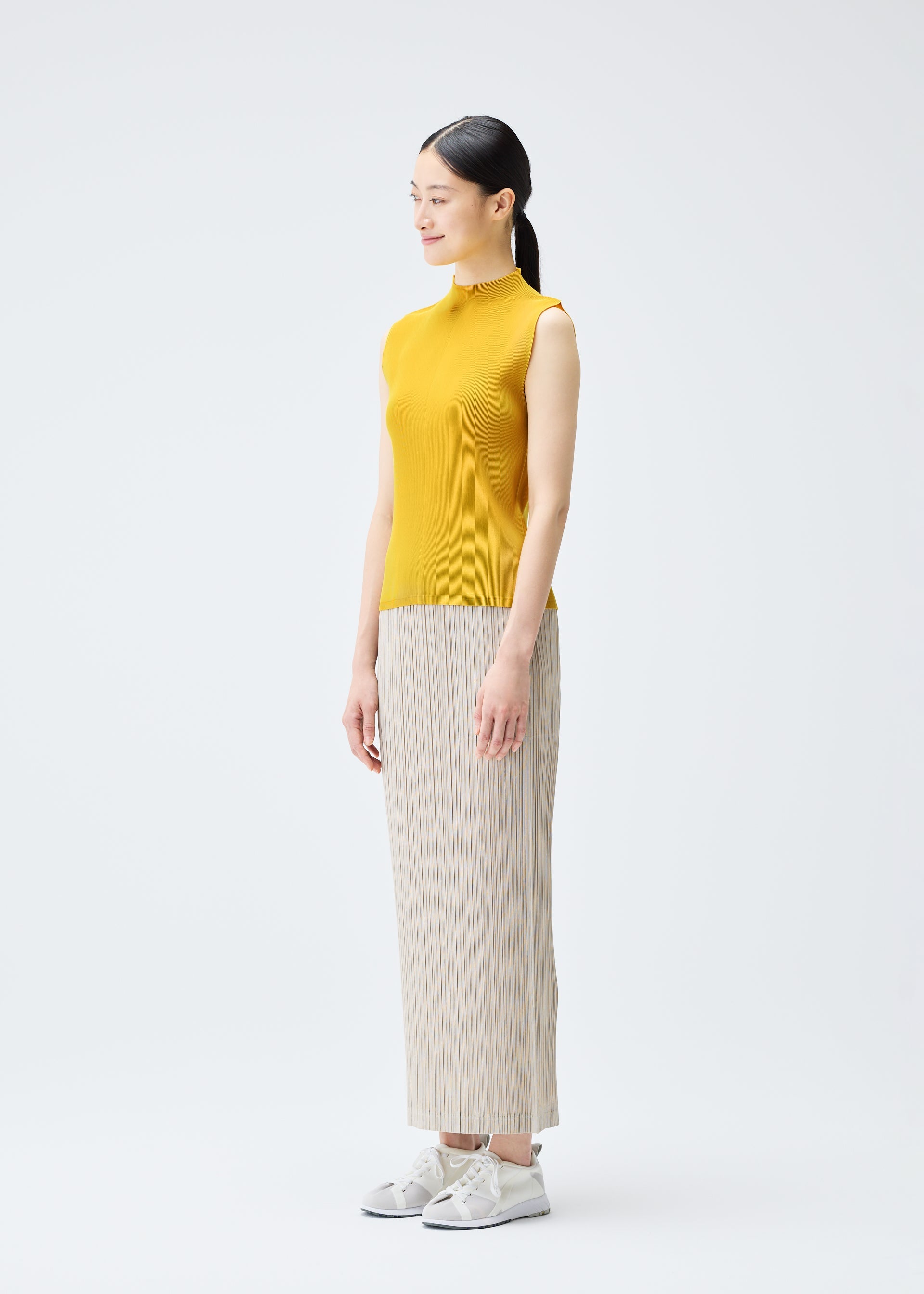 A model wears the PLEATS PLEASE ISSEY MIYAKE THICKER BOTTOMS 1 skirt.