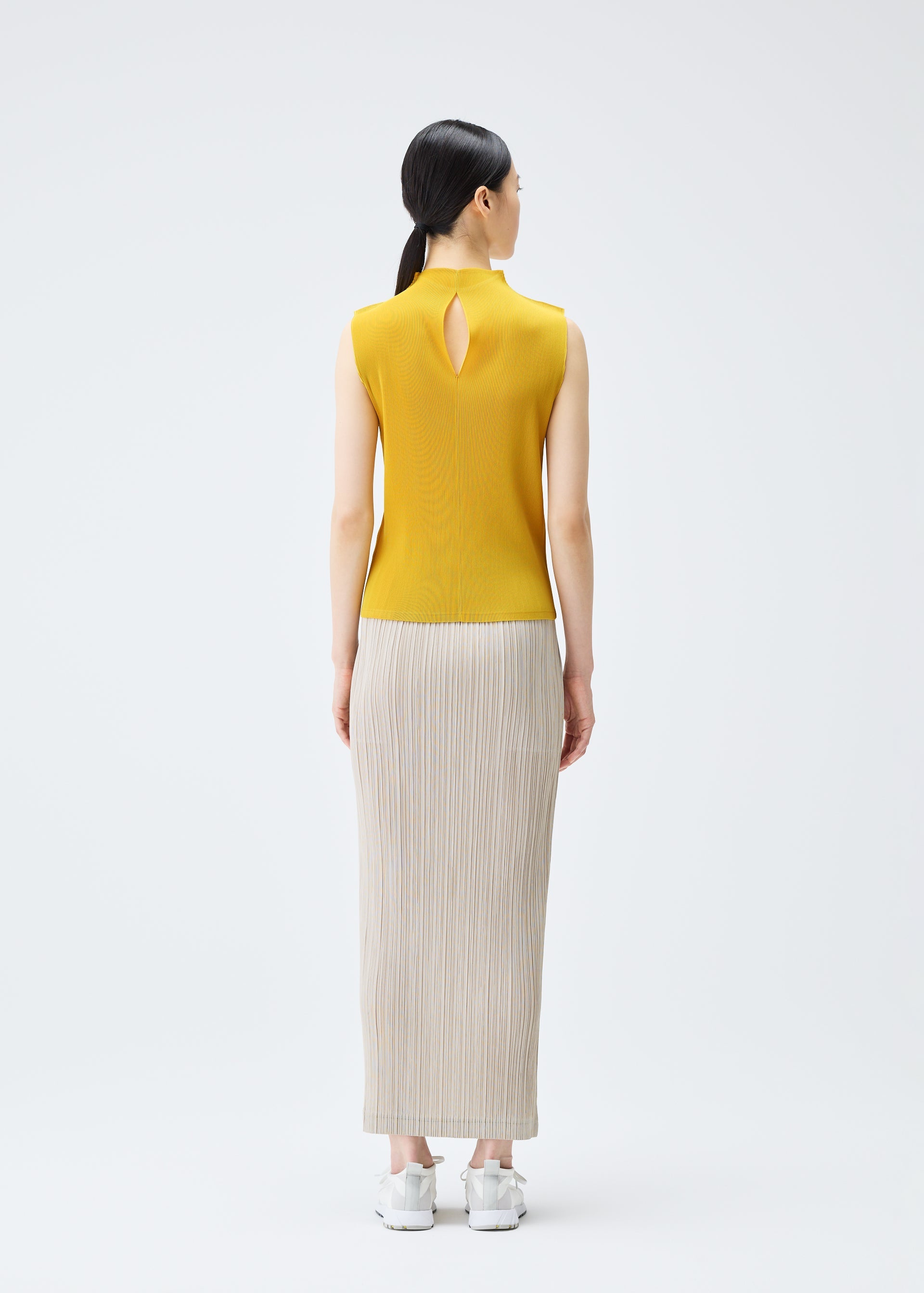 A model wears the PLEATS PLEASE ISSEY MIYAKE THICKER BOTTOMS 1 skirt.
