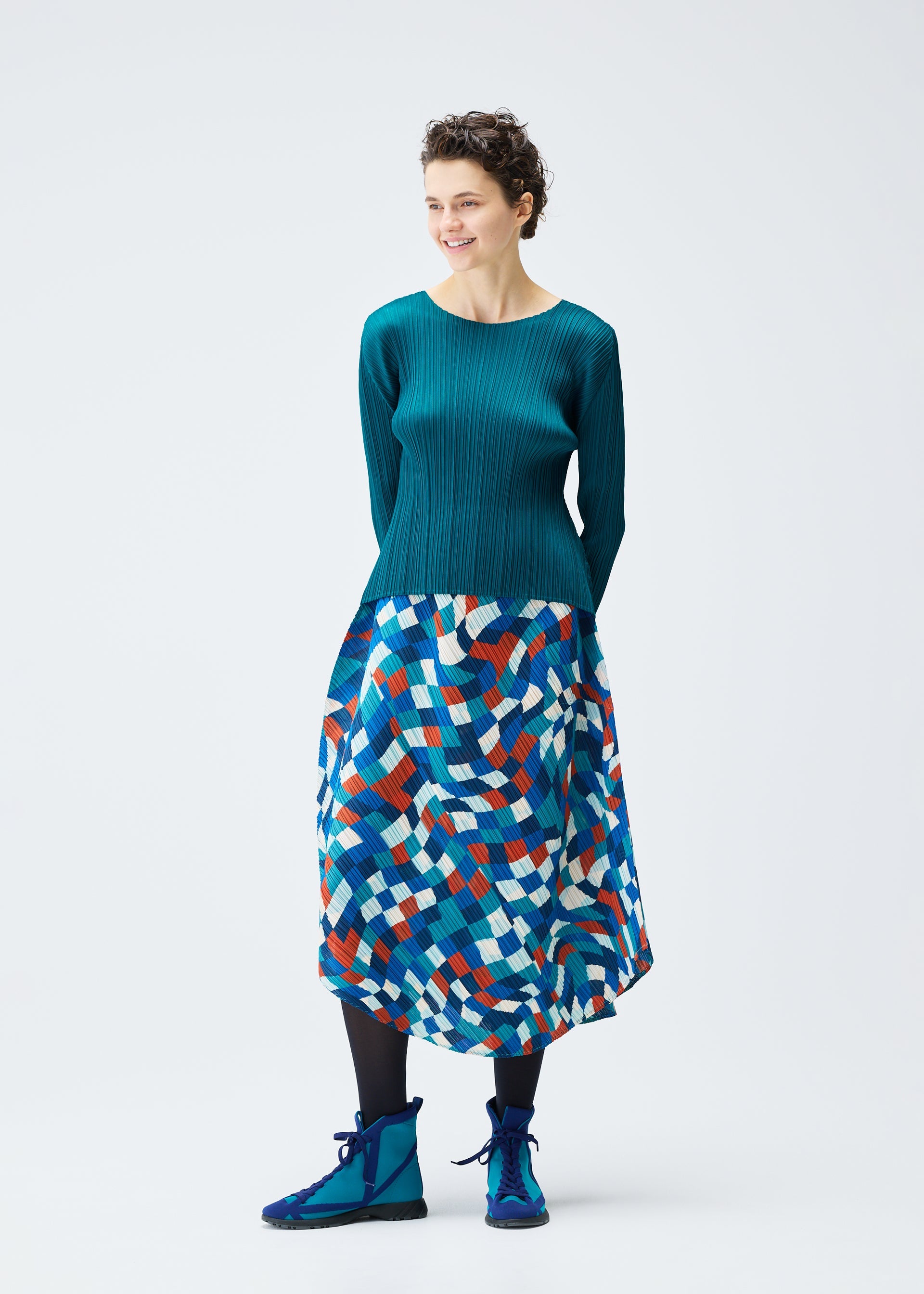 A model wears the PLEATS PLEASE ISSEY MIYAKE DANCING SQUARE skirt.