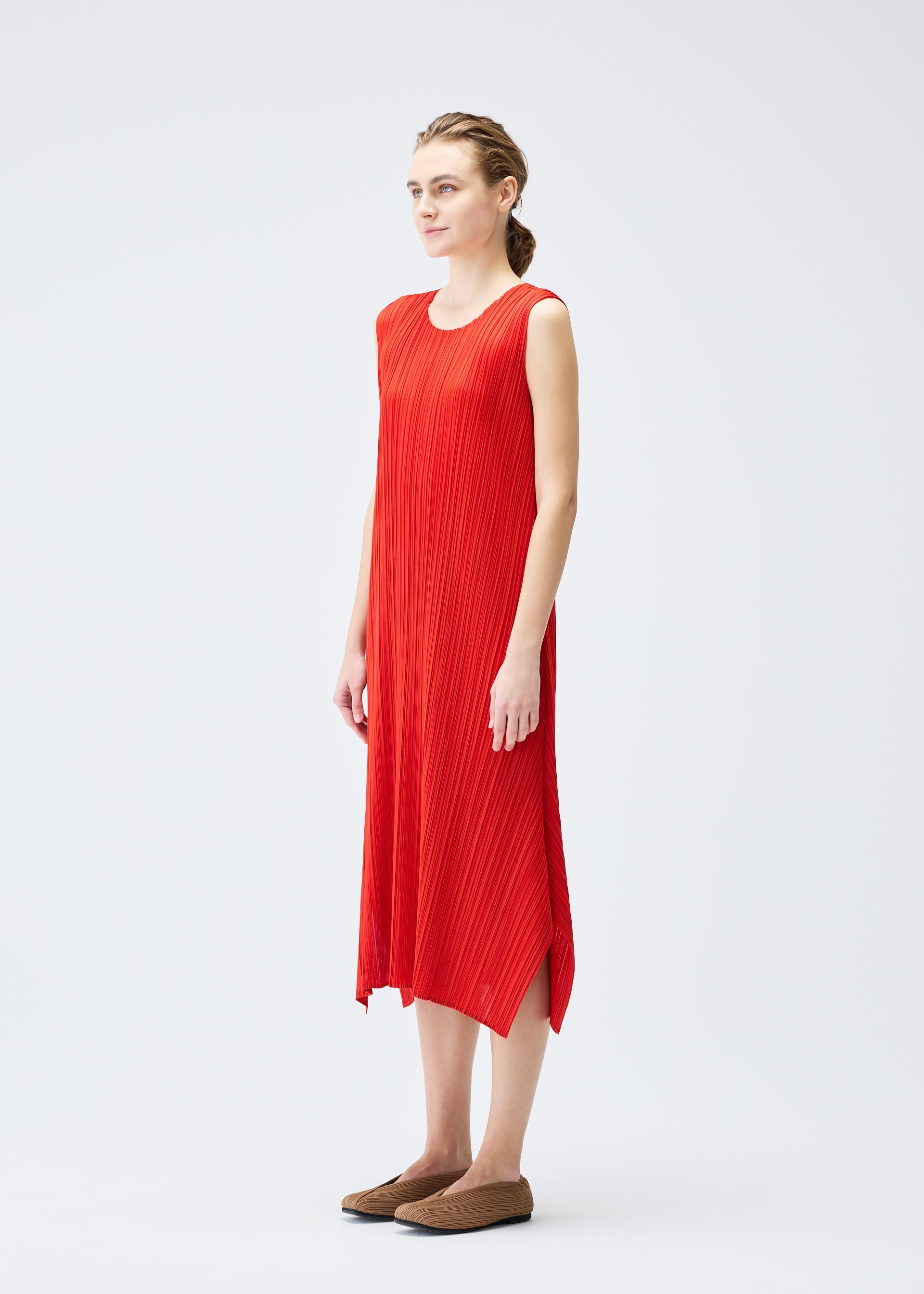 A model wears the PLEATS PLEASE ISSEY MIYAKE MONTHLY COLORS JULY dress.