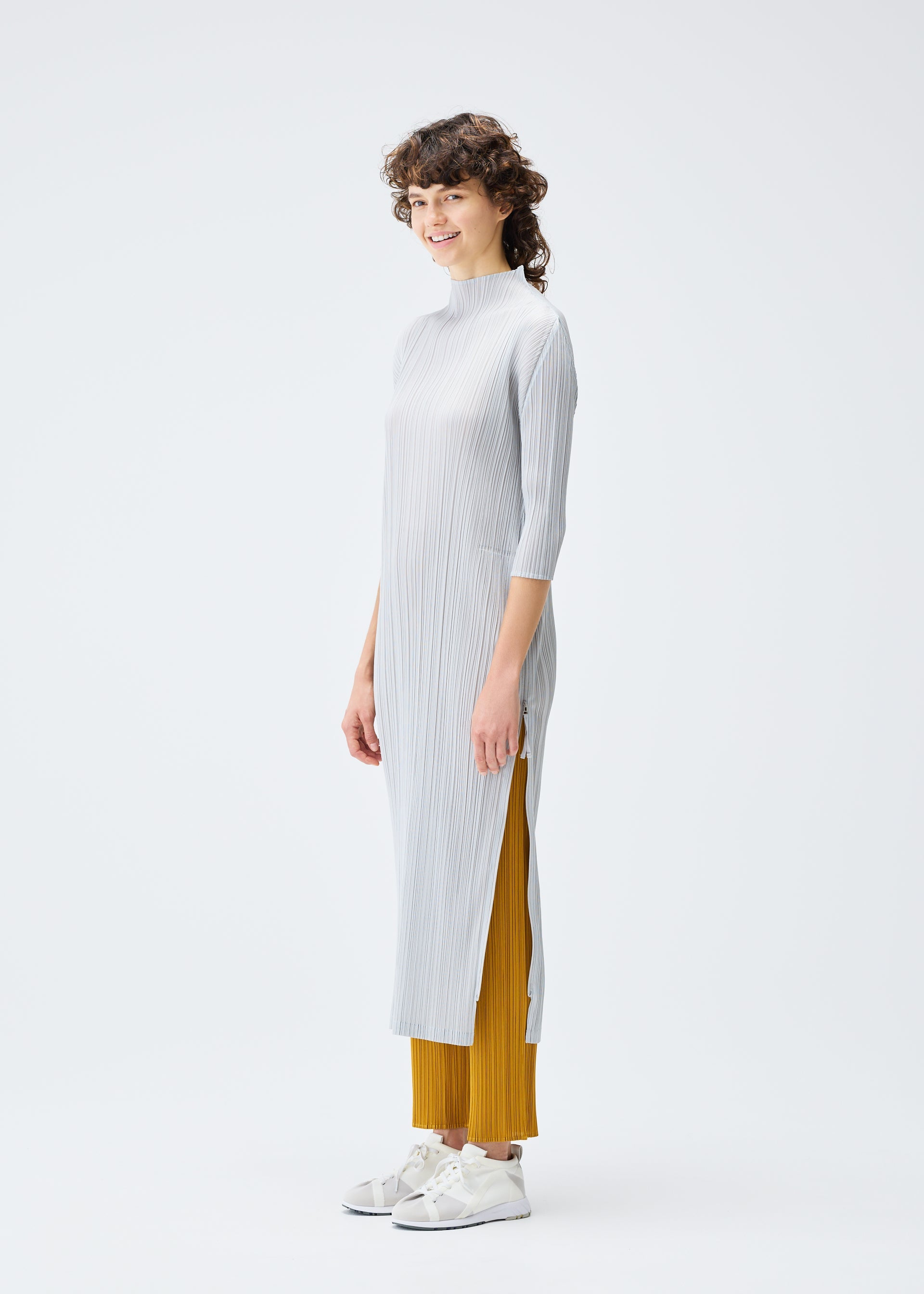A model wears the PLEATS PLEASE ISSEY MIYAKE MONTHLY COLORS SEPTEMBER dress.