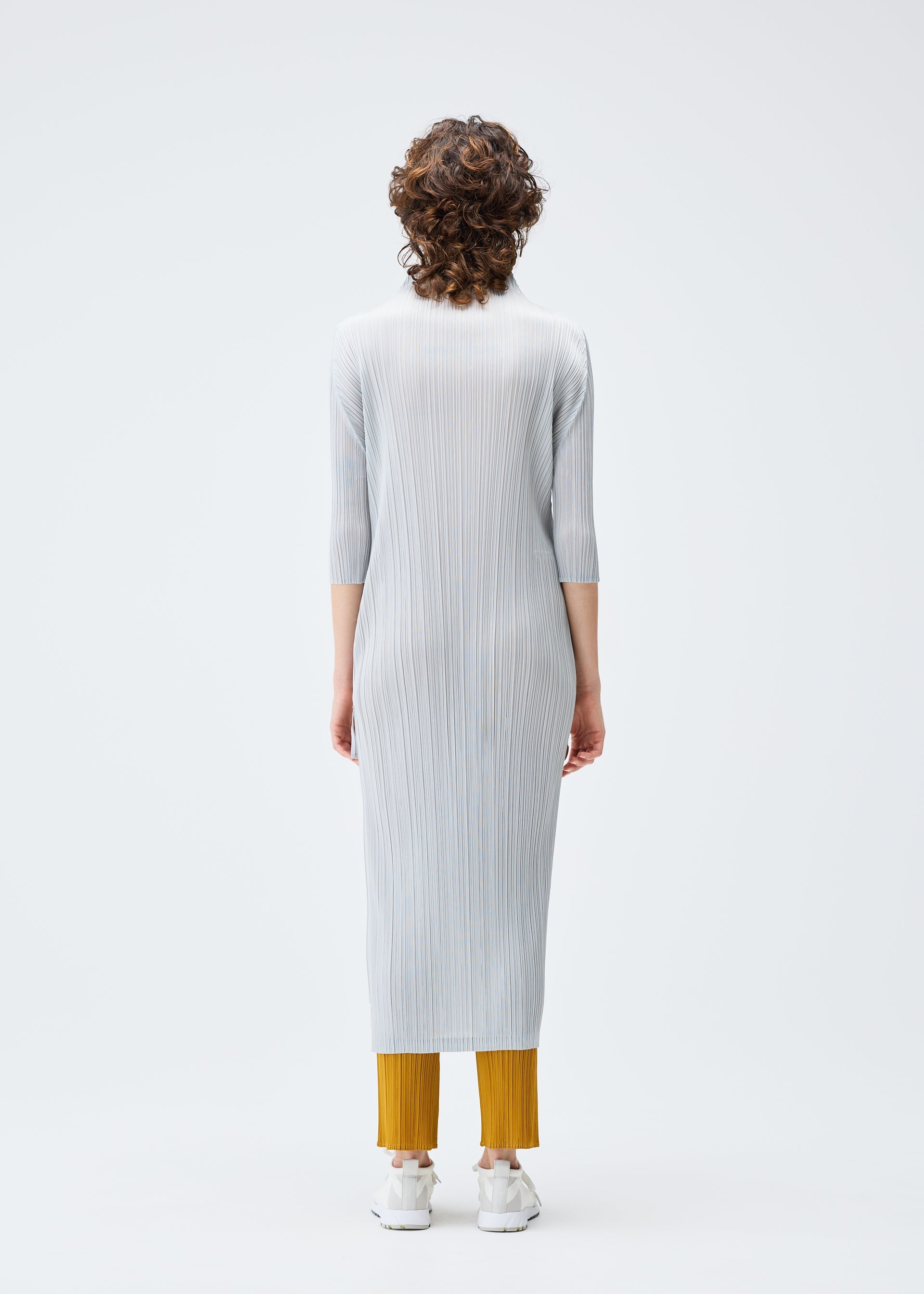A model wears the PLEATS PLEASE ISSEY MIYAKE MONTHLY COLORS SEPTEMBER dress.