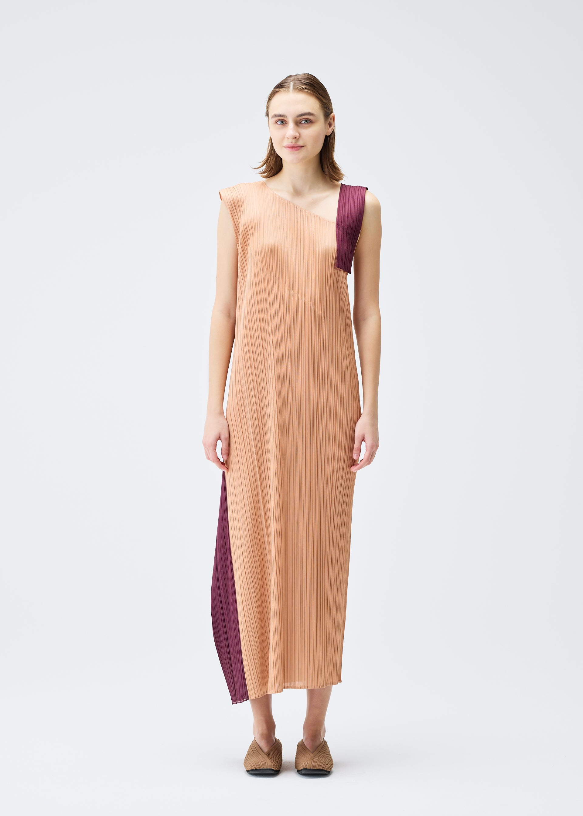 A model wears the PLEATS PLEASE ISSEY MIYAKE POINTE dress.