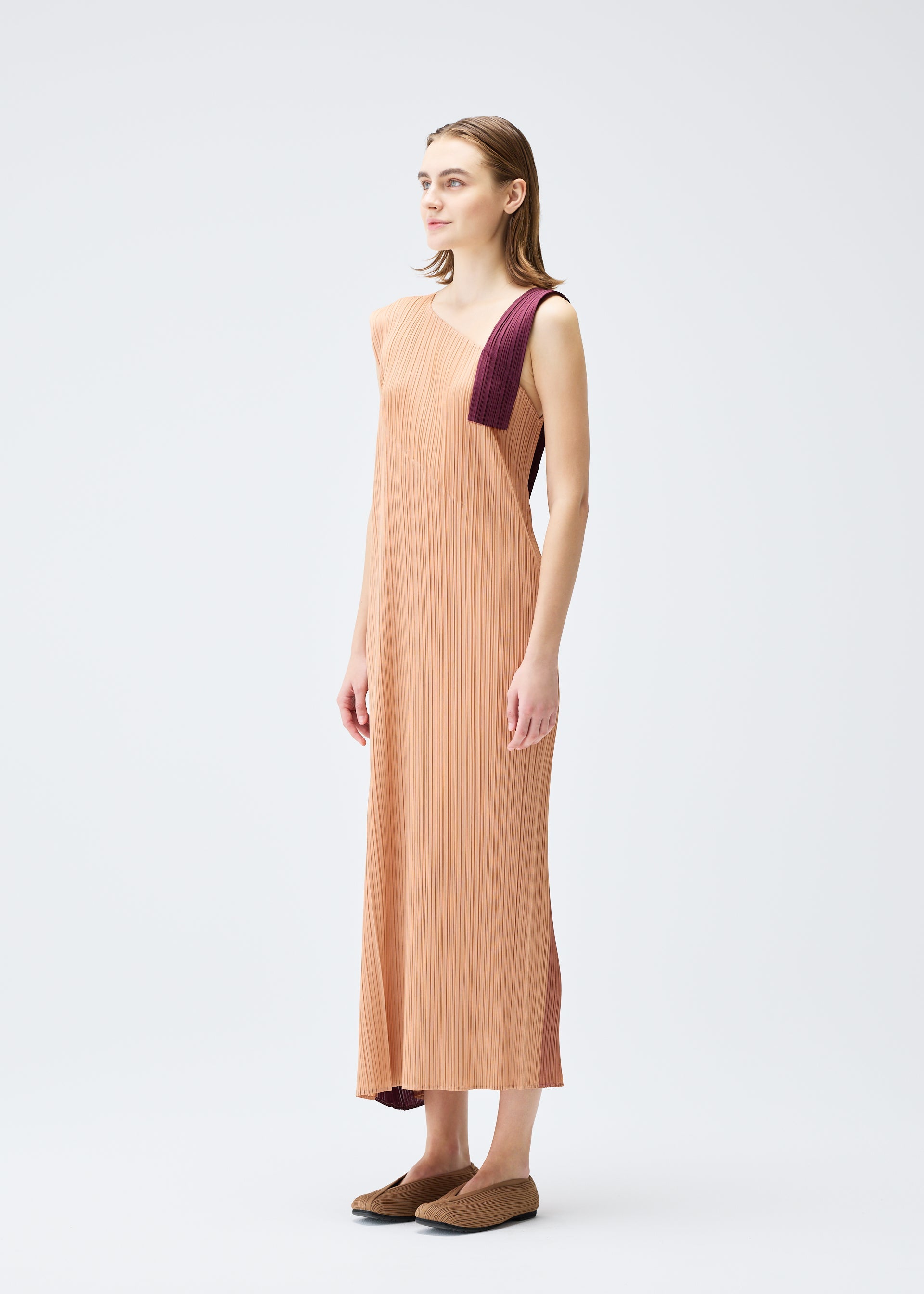 A model wears the PLEATS PLEASE ISSEY MIYAKE POINTE dress.