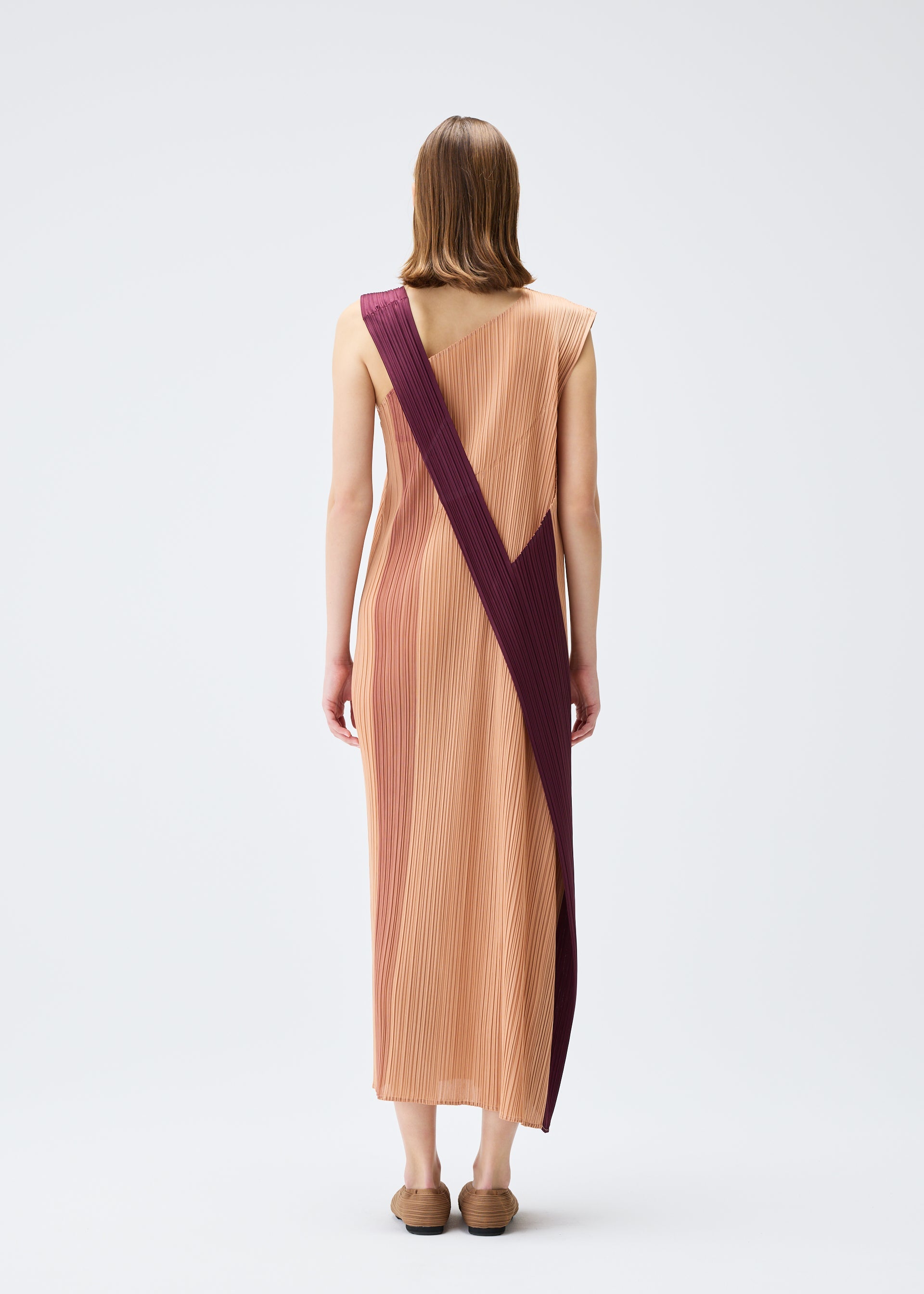 A model wears the PLEATS PLEASE ISSEY MIYAKE POINTE dress.