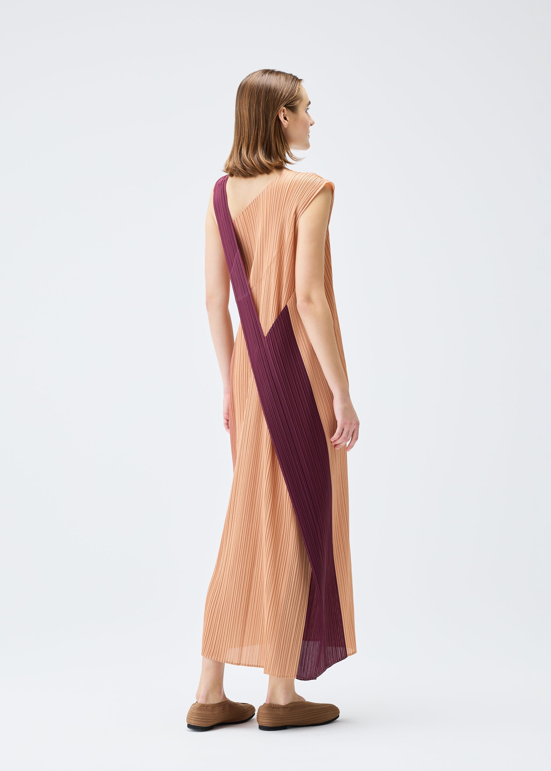 A model wears the PLEATS PLEASE ISSEY MIYAKE POINTE dress.