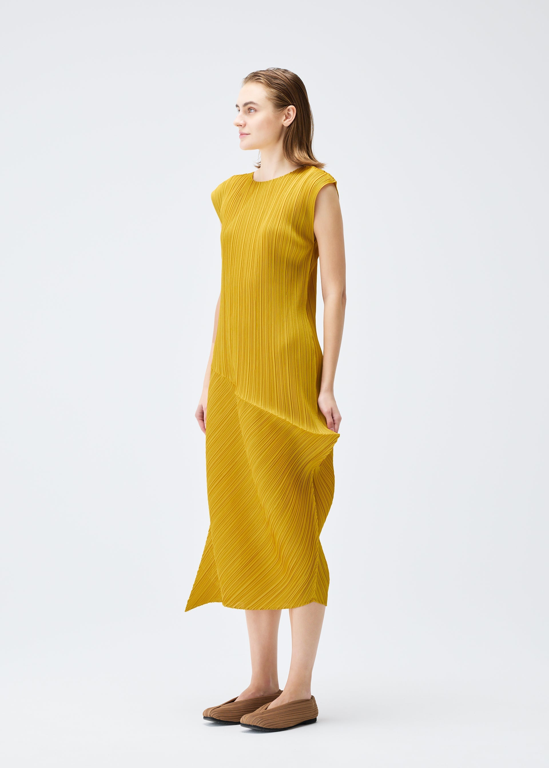 A model wears the PLEATS PLEASE ISSEY MIYAKE LEAP dress.