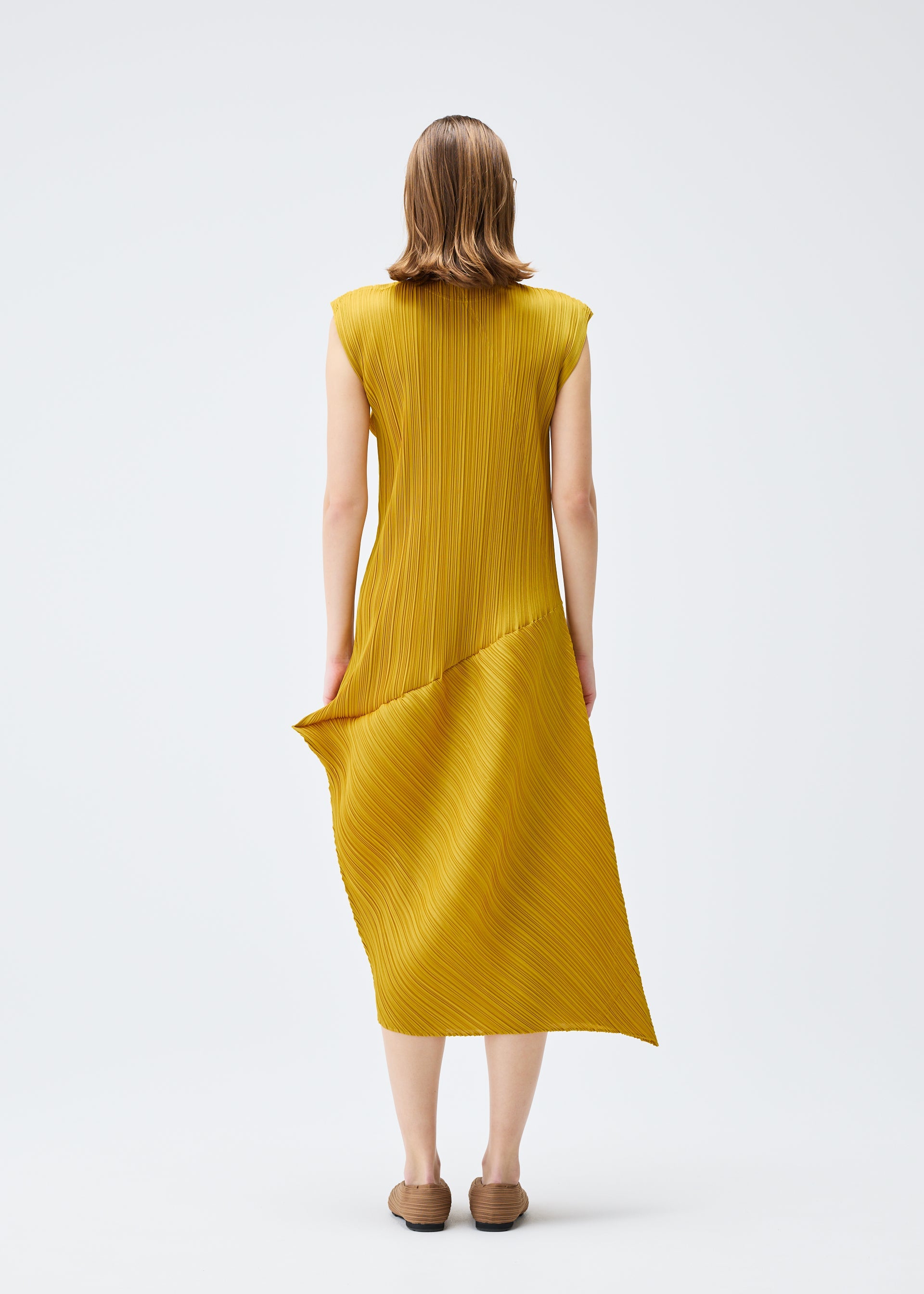 A model wears the PLEATS PLEASE ISSEY MIYAKE LEAP dress.