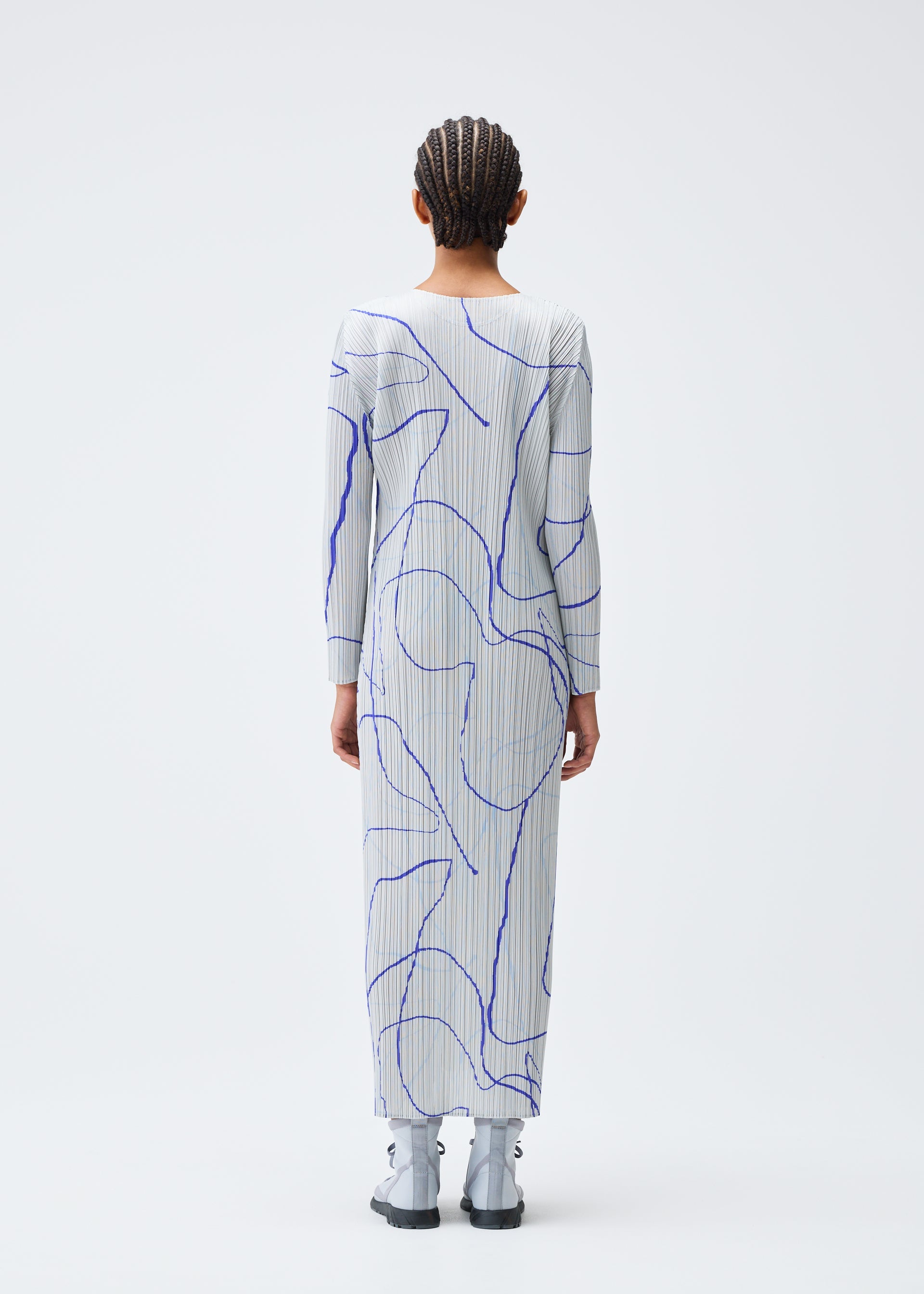 A model wears the PLEATS PLEASE ISSEY MIYAKE PAUSE dress.