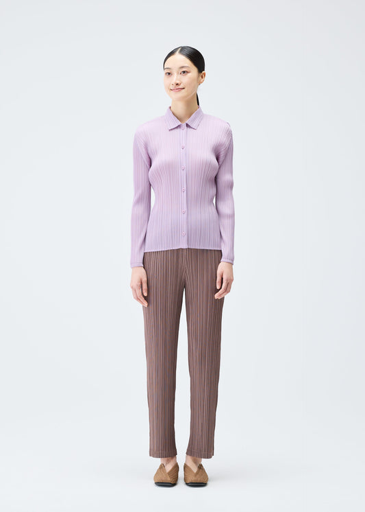 A model wears the PLEATS PLEASE ISSEY MIYAKE PLEATS SHIRT shirt.