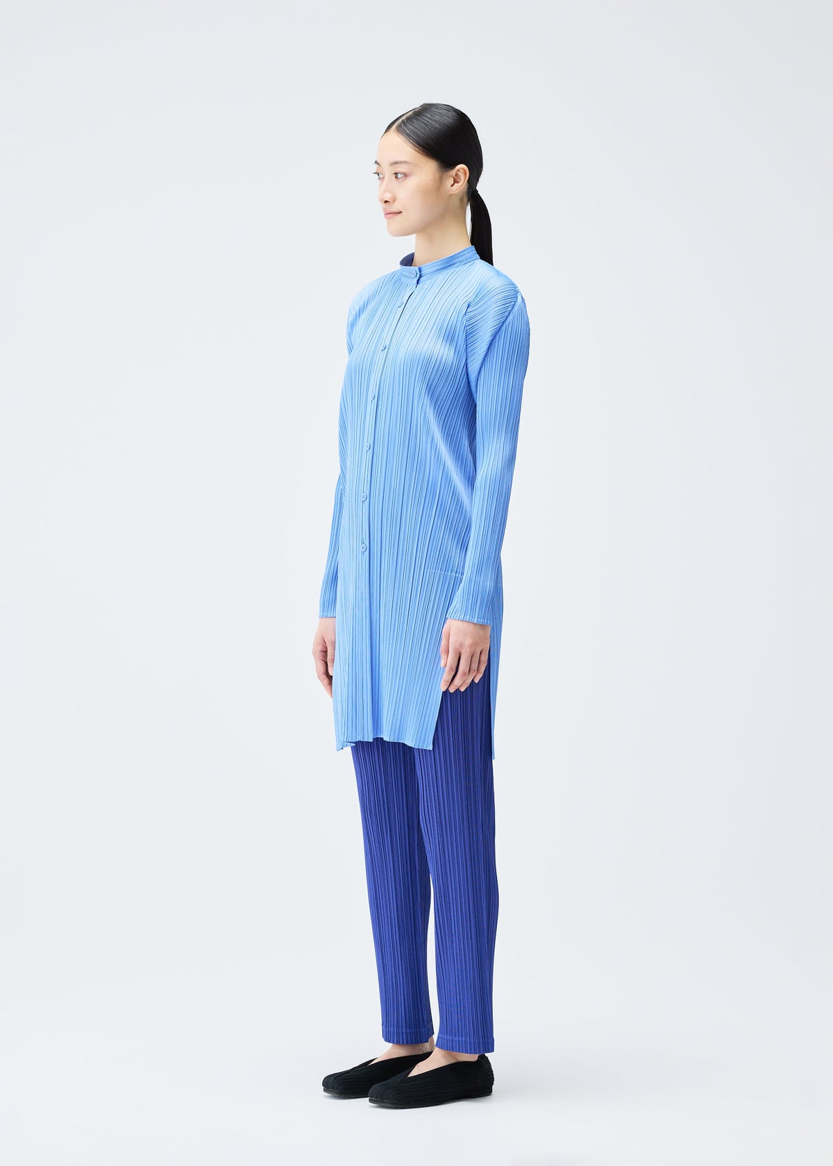 A model wears the PLEATS PLEASE ISSEY MIYAKE PLEATS SHIRT shirt.