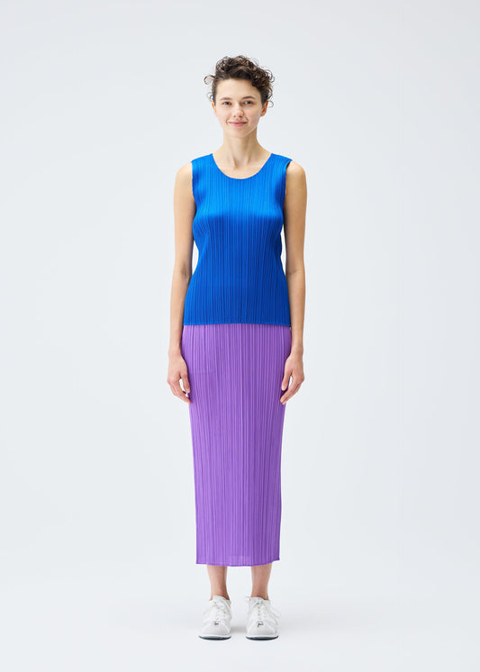 A model wears the PLEATS PLEASE ISSEY MIYAKE MONTHLY COLORS AUGUST top.