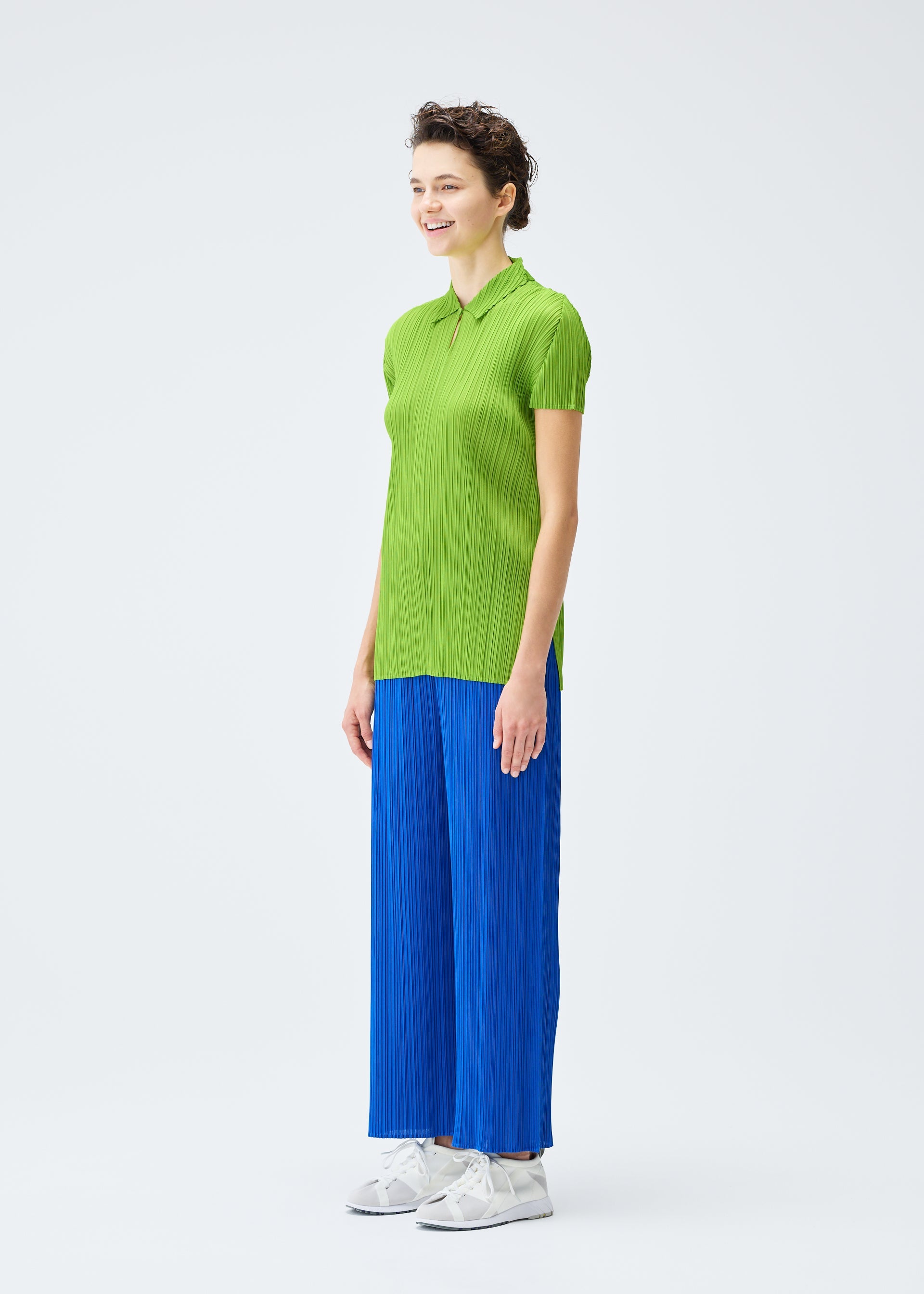 A model wears the PLEATS PLEASE ISSEY MIYAKE MONTHLY COLORS AUGUST top.