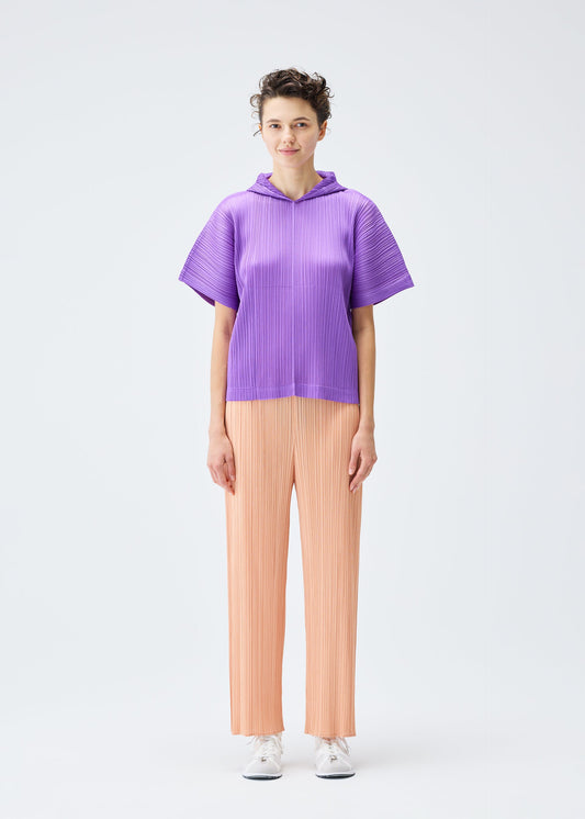 A model wears the PLEATS PLEASE ISSEY MIYAKE MONTHLY COLORS AUGUST top.