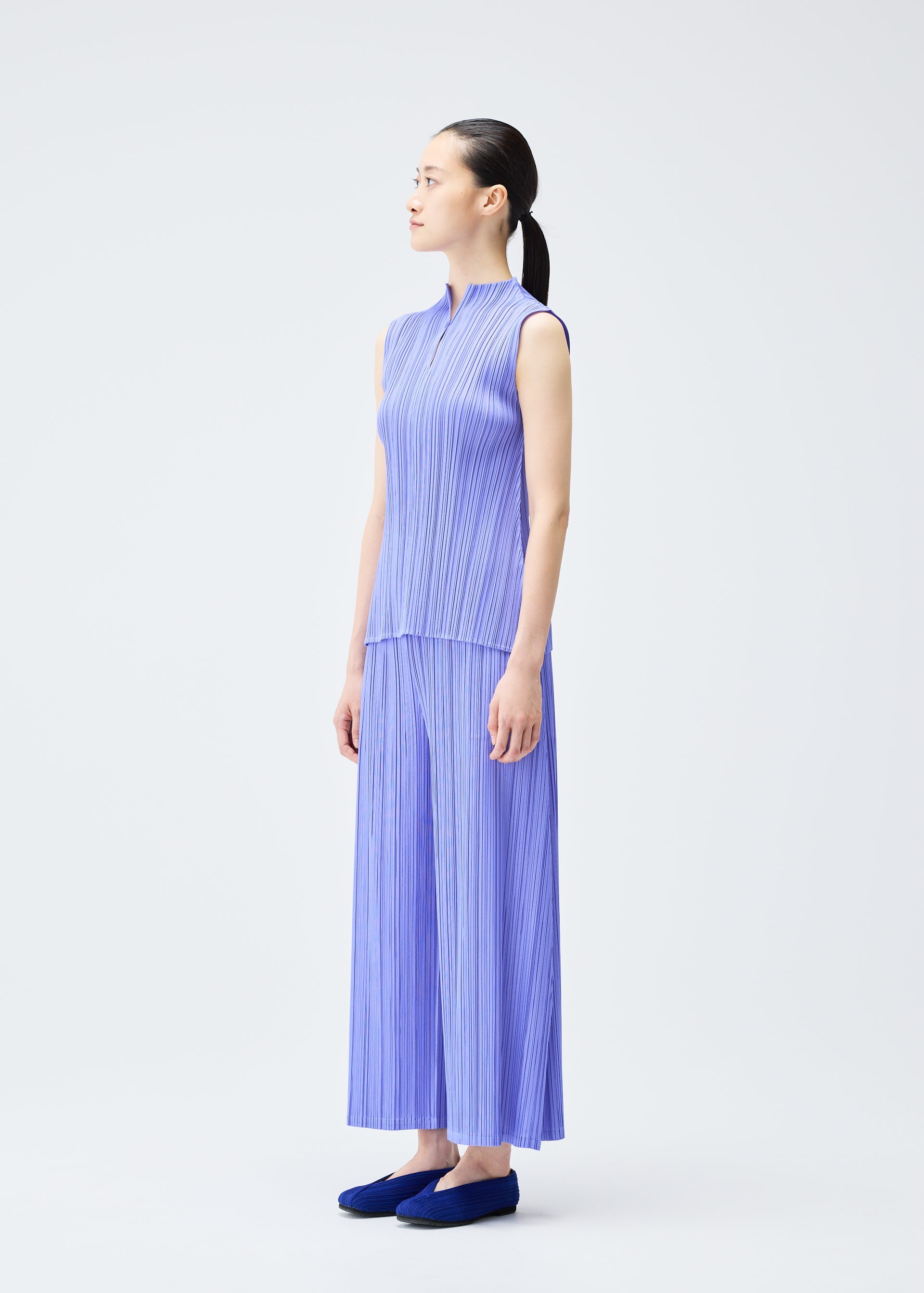 A model wears the PLEATS PLEASE ISSEY MIYAKE MELLOW PLEATS top.