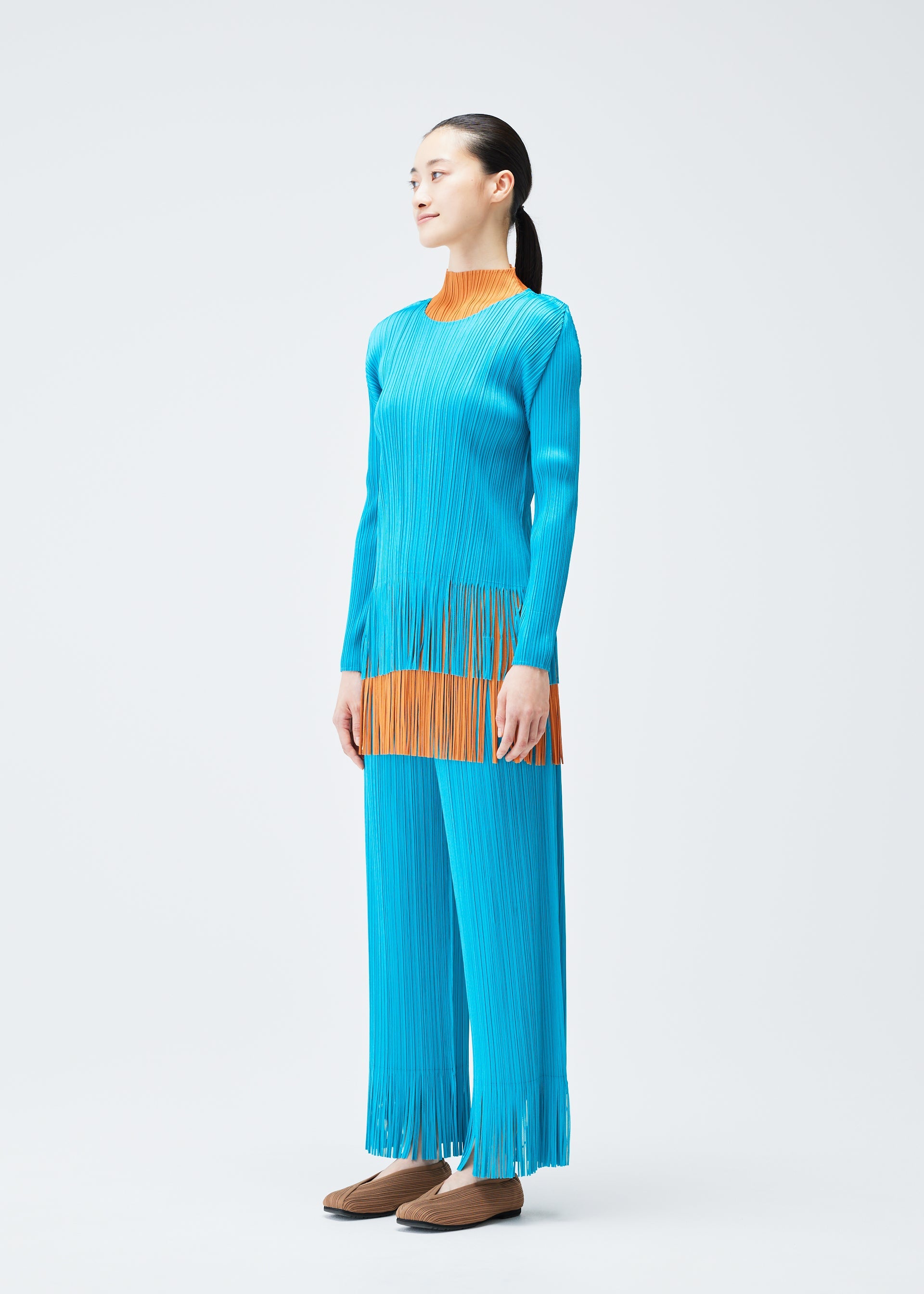 A model wears the PLEATS PLEASE ISSEY MIYAKE WAVE top.