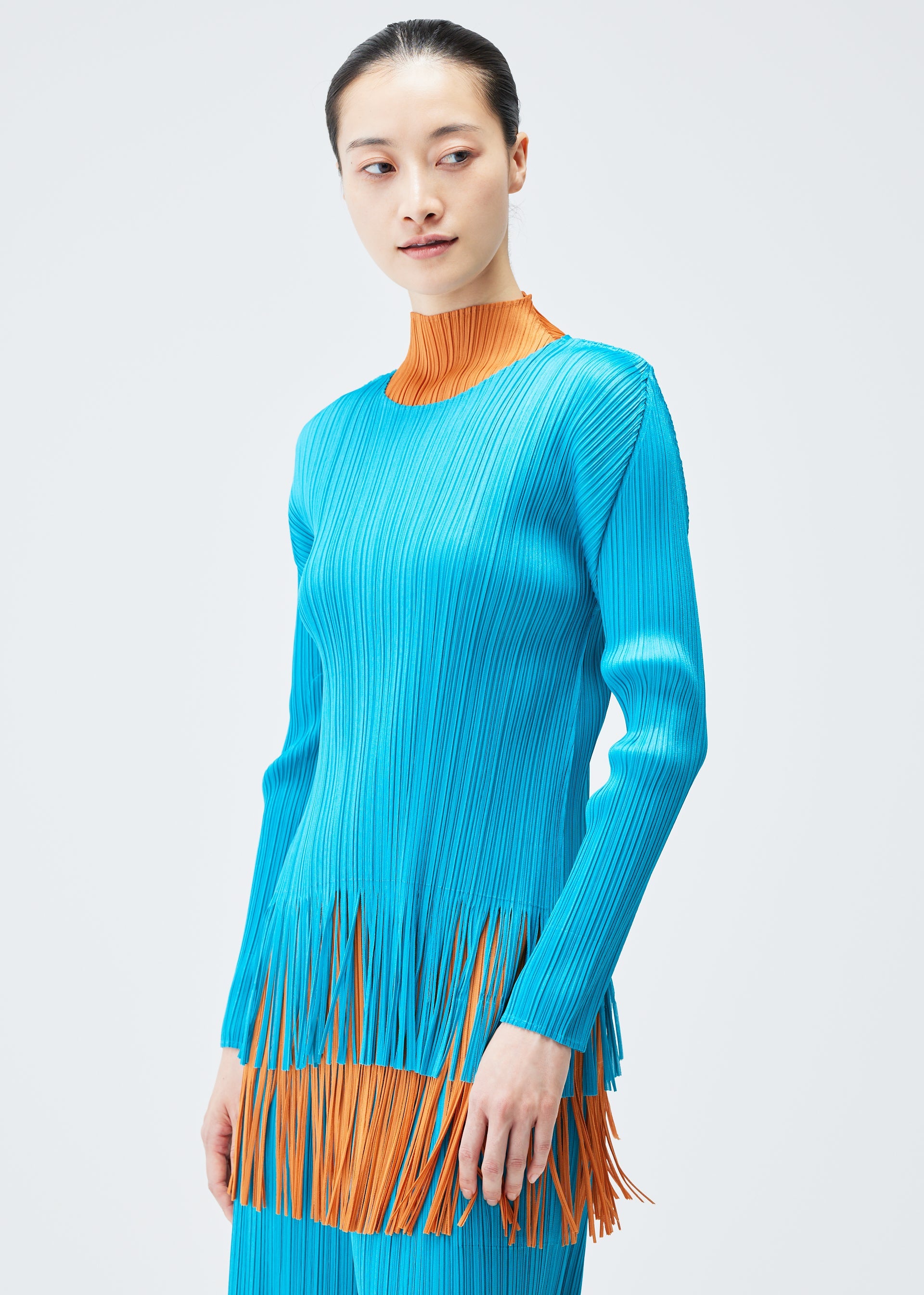 A model wears the PLEATS PLEASE ISSEY MIYAKE WAVE top.